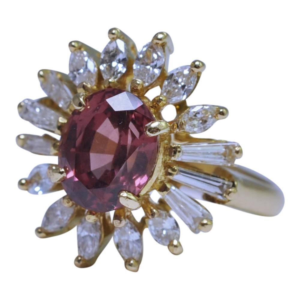 Untreated Malaya garnet and diamond sunburst ring in 18ct gold; the garnet is a beautiful orangey/pinkish red colour and weighs 2,79ct.  The Malaya garnet is typically never treated or enhanced in any way, with its unique colour being totally