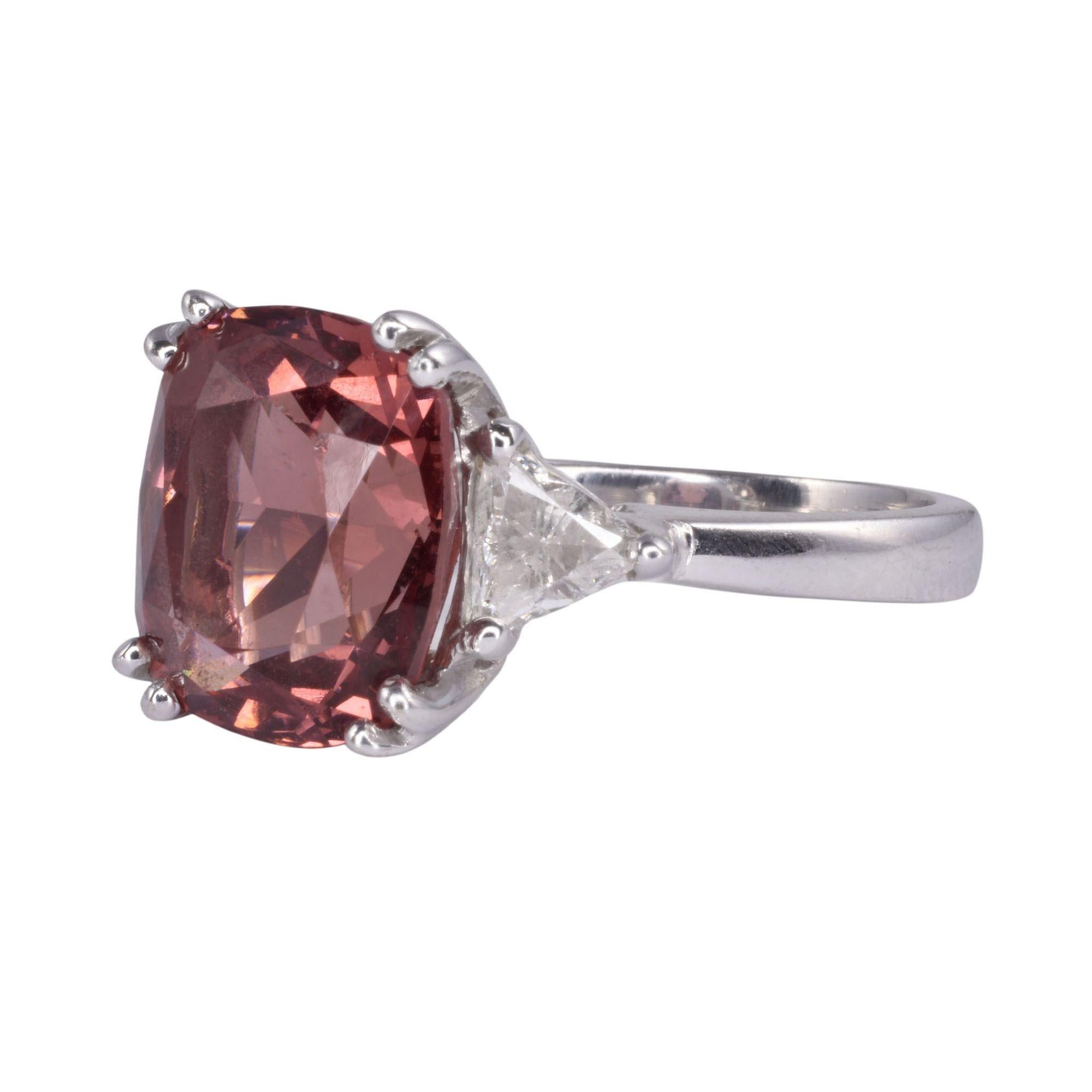 Estate Malaya garnet white gold ring. This 14 karat white gold ring features a Malaya garnet at approximately 8.0 carats. It is accented with two side diamonds at .62 carat total weight with VS clarity & J color. This garnet ring is a size 8. [KIMH
