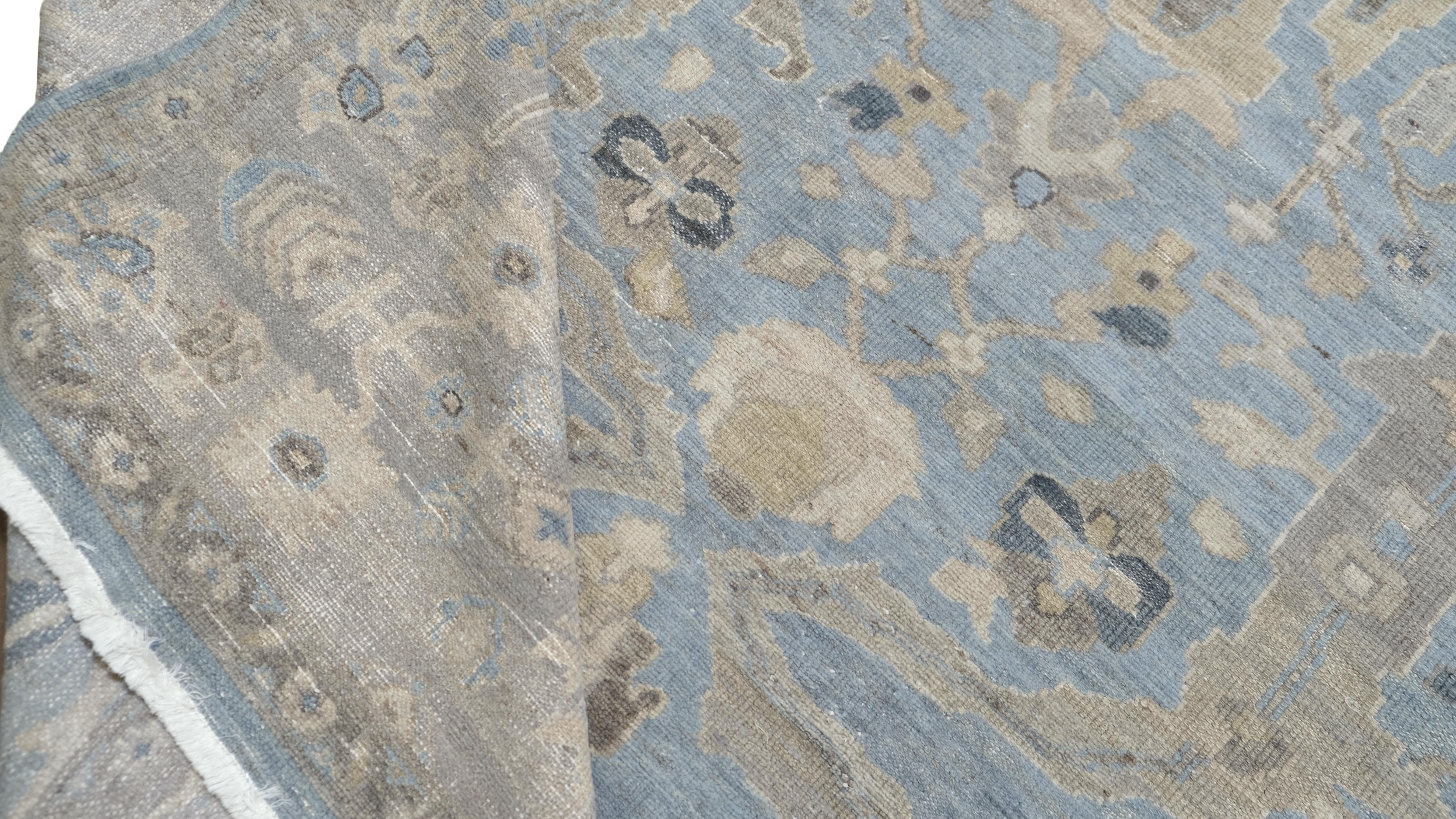 Elevate your space with the timeless elegance of this hand-knotted in malayer weave using fine wool rug. Featuring a sophisticated light blue background adorned with intricate floral and geometric motifs in beige, blue and ivory, this rug embodies