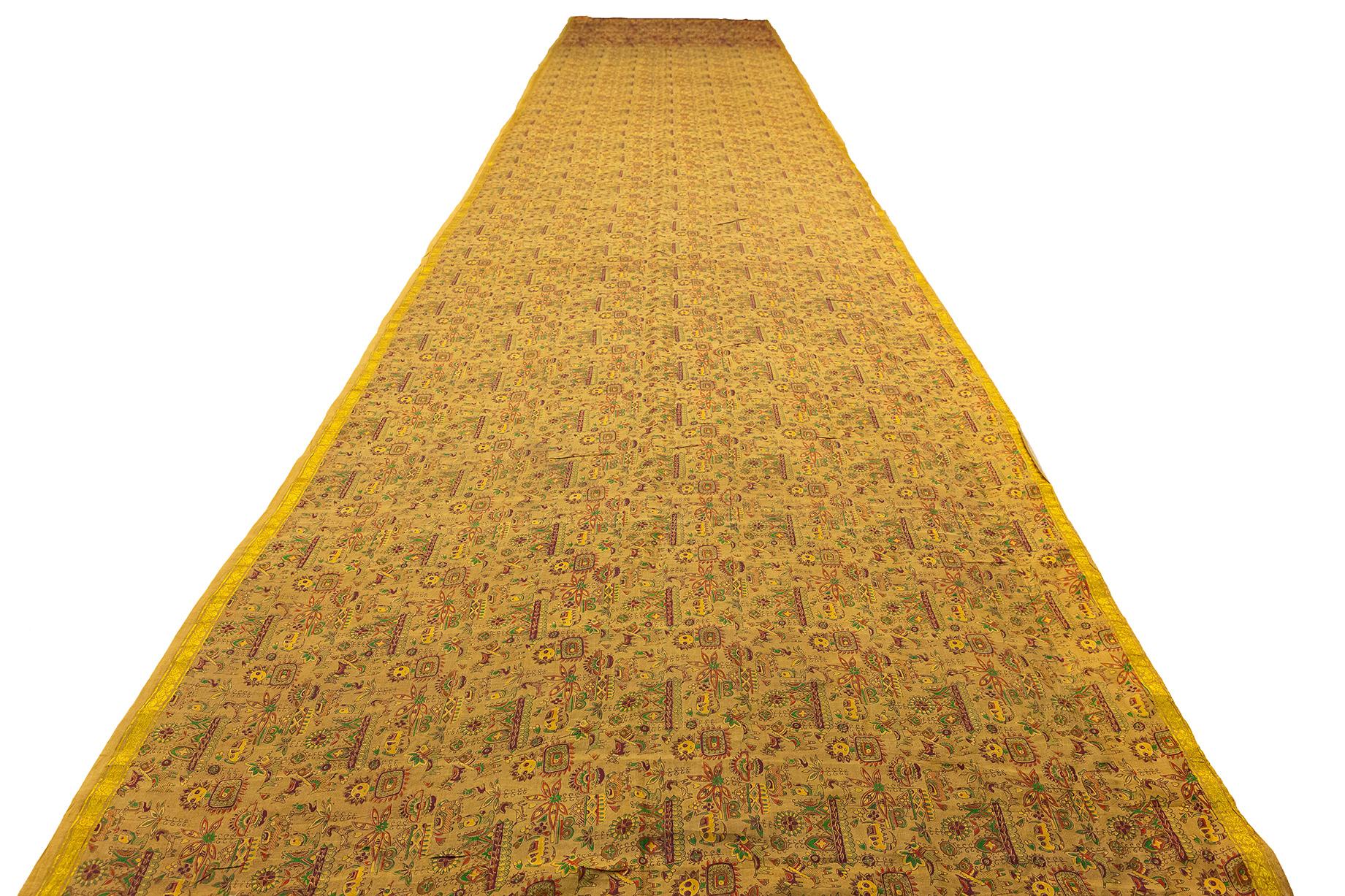 This exquisite Malaysian textile, measuring an impressive 109 x  579 cm, is a remarkable example of traditional Southeast Asian craftsmanship. The piece showcases the rich cultural heritage and intricate artistry that has been passed down through