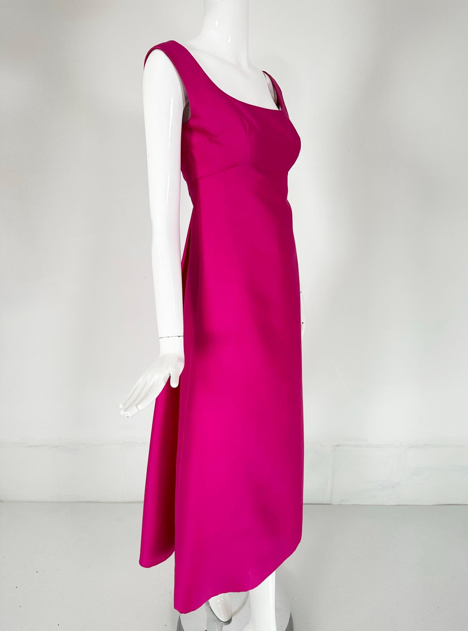 Malcolm Starr early 1960s fuchsia pink silk twill evening dress. A beautiful dress for any special occasion. Dress has low, scooped neckline at the front with high bust darts and an empire waist, continuing in an a line to the hem. The dress back is