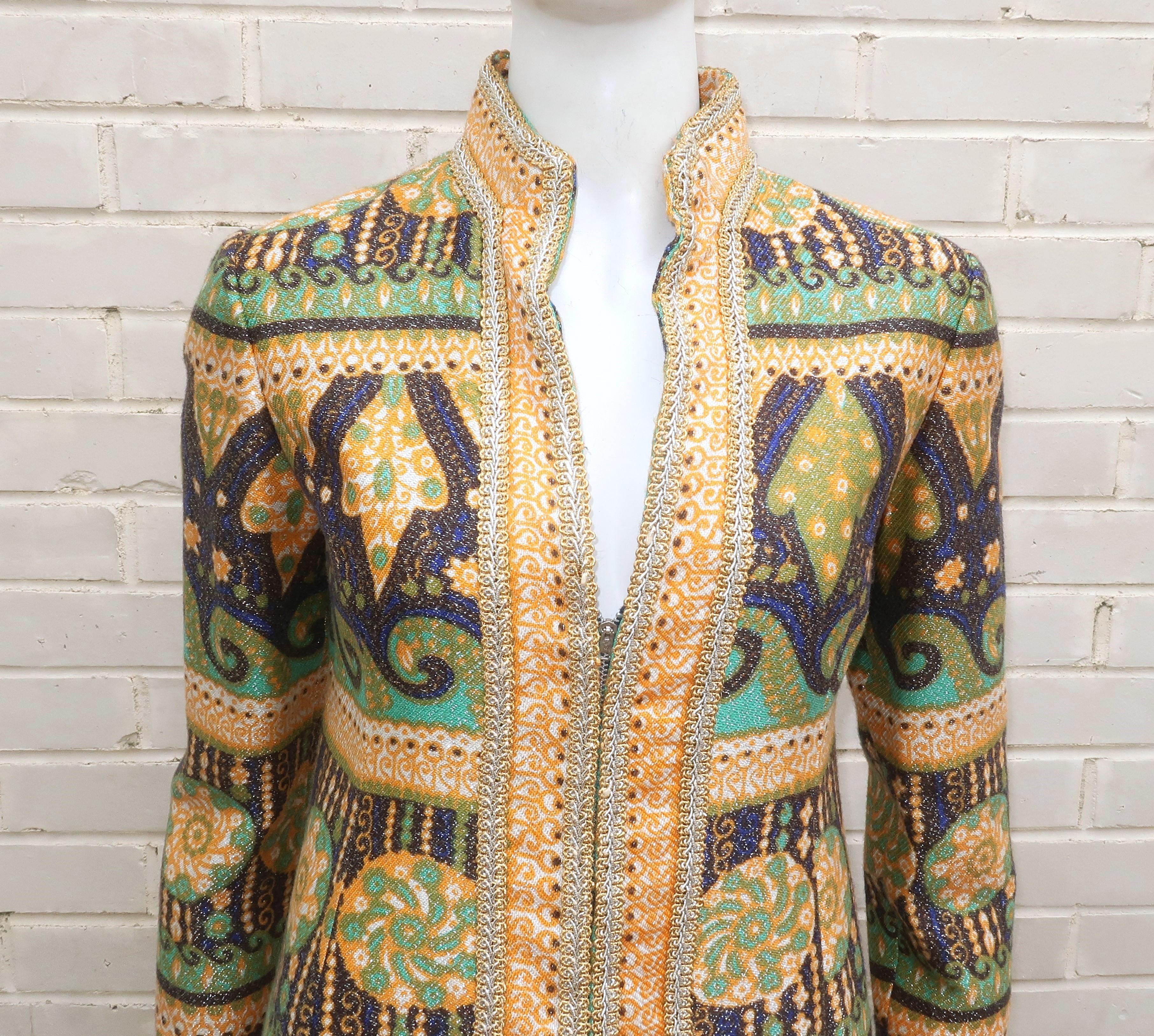 1960’s Elinor Simmons for Malcolm Starr gold lamé pant suit in shades of blue, aqua, orange and green with an exotic geometric print.  The Nehru style coat zips at the front with gold and silver braid trim.  The coordinating pants zip at the front