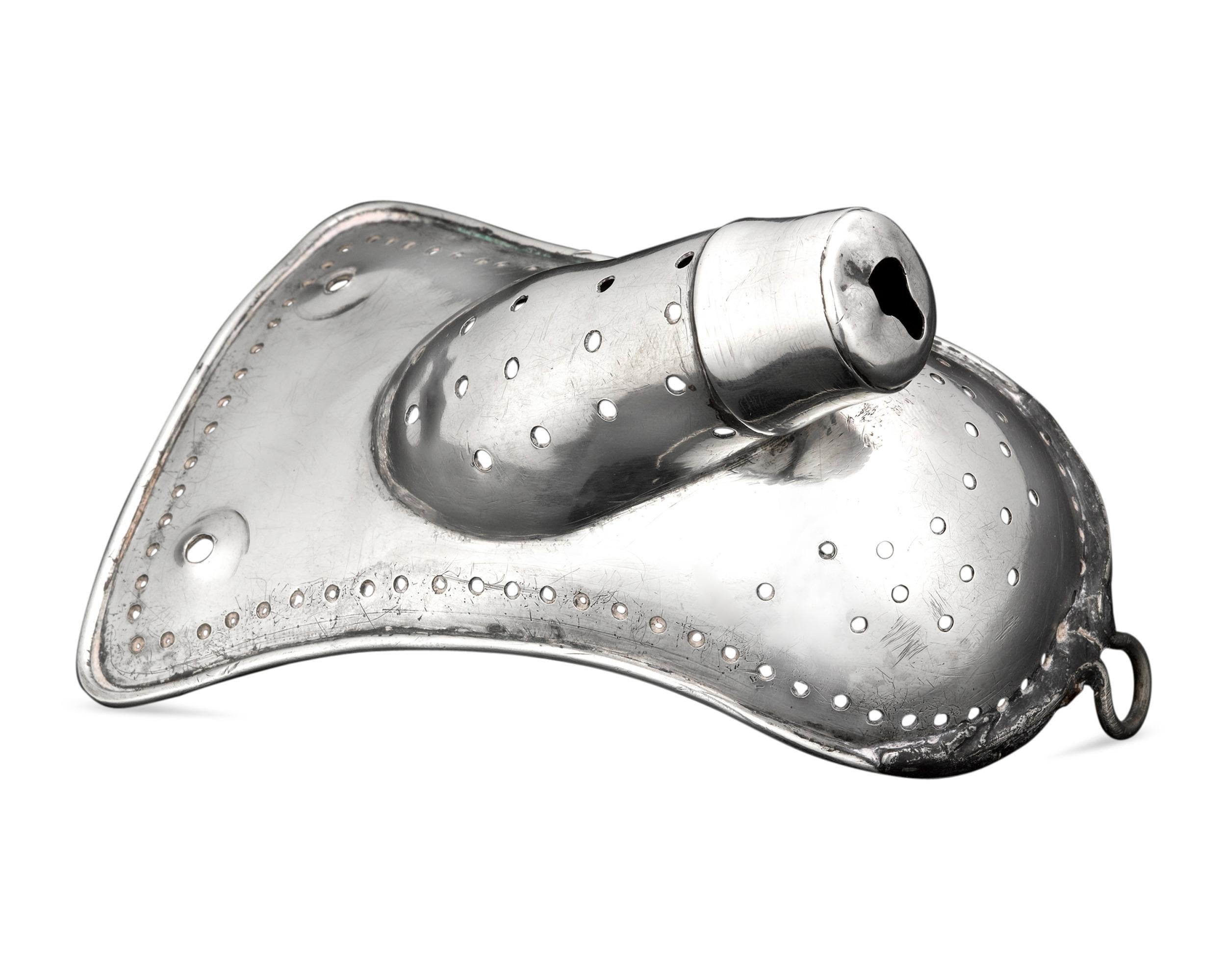 This remarkably rare and intriguing 19th century silver adolescent chastity device was designed to accommodate the male anatomy. Perforated and featuring wire-work rims, this device was most likely fitted into a leather harness-like belt and meant