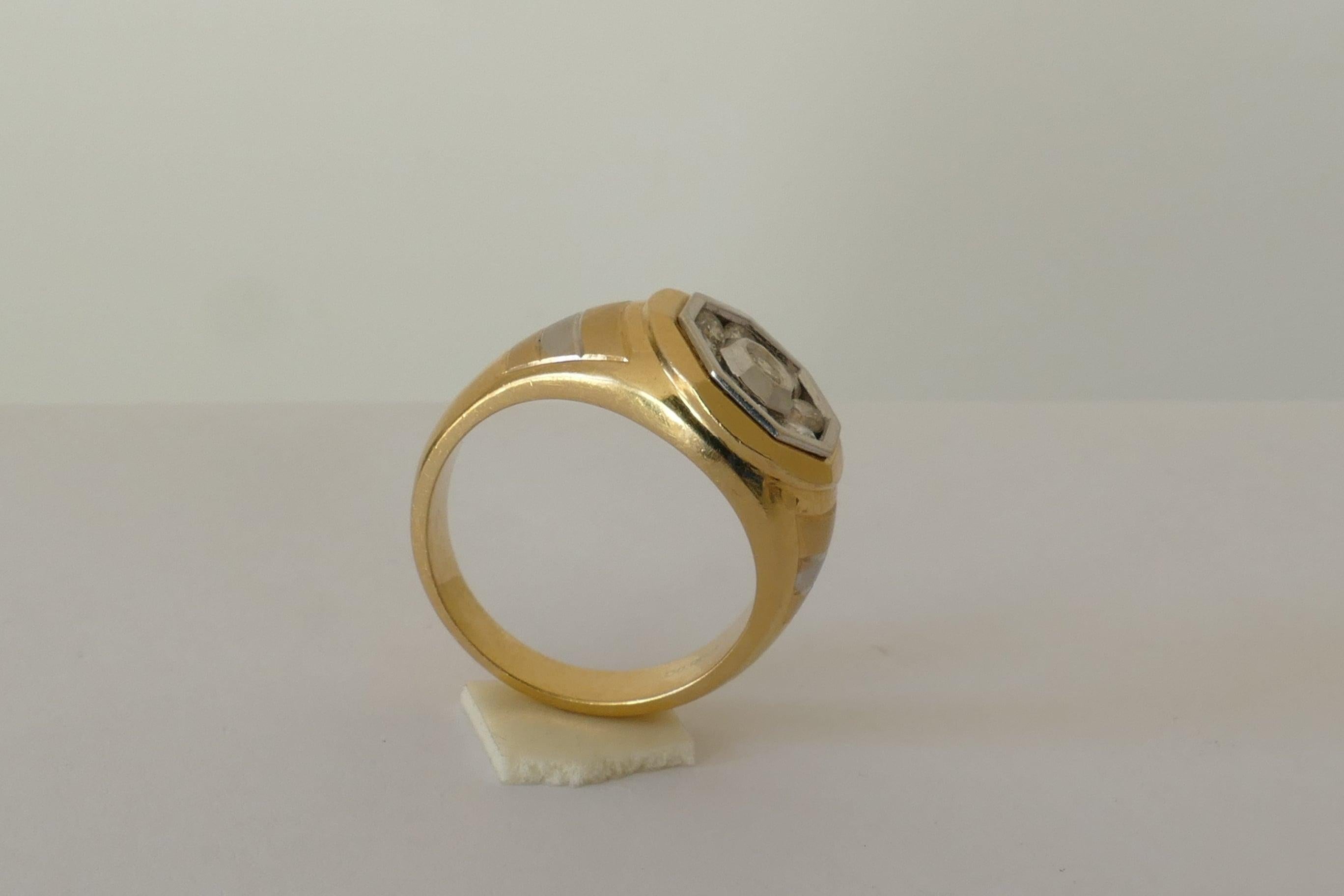 Excellent Colour Diamonds G/H make up this this Male - but could also be appealing to a Female - Ring. 
There are 9 Diamonds totalling close to 1 carat in weight.
The Ring shows a very attractive Design of Yellow Gold striped with White Gold down