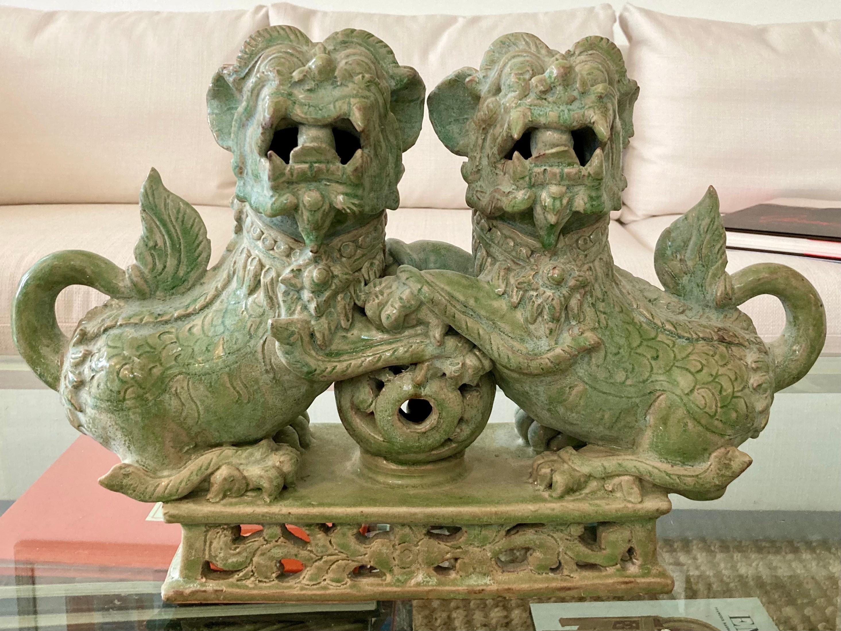 Beautiful male foo dogs holding and protecting the earth. Very rare find and interesting take on the foo dogs considering they're both male.