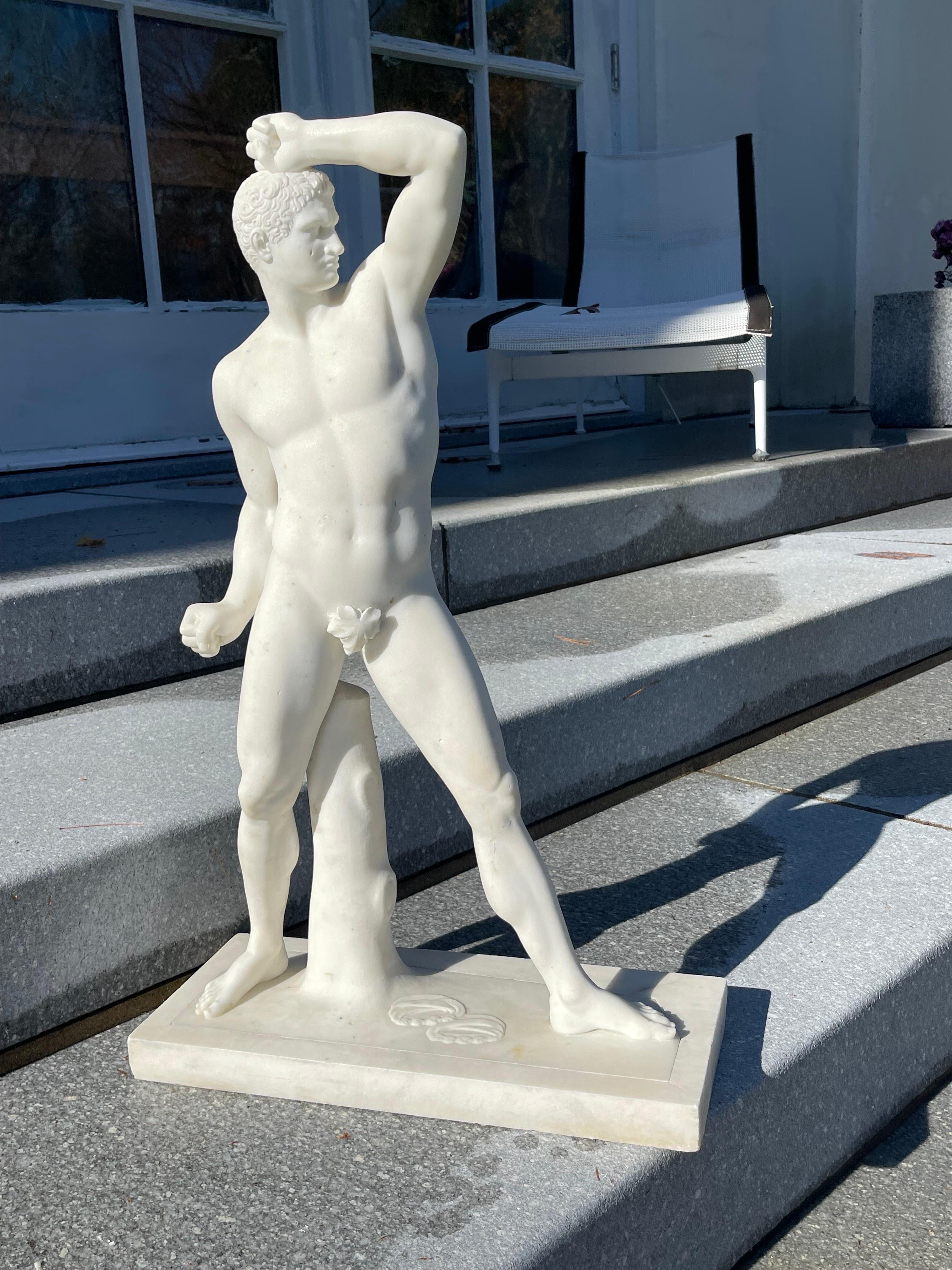This beautiful example of the Greek boxer was hand carved of Statuario Marble in Florence during the Grand Tour period after the antique original. The subject has a victorious pose flexing every muscle, the fighting gloves casually thrown on the