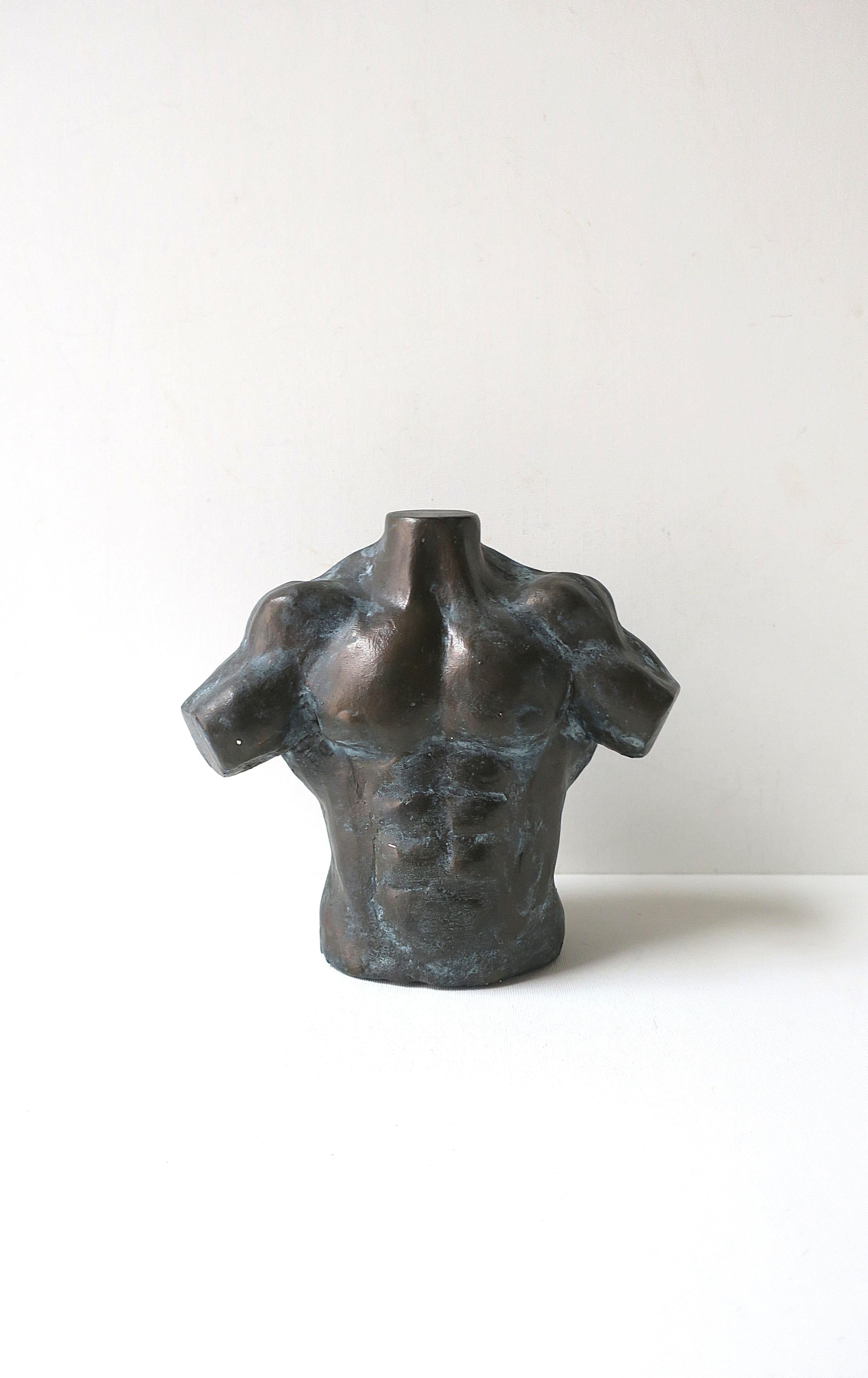 A substantial plaster/composition male torso sculpture, signed and dated by artist, circa 1990s. A male torso sculpture with muscular definition and bronze-like finish, artist initials and dated ('99) on bottom as shown in last image. 