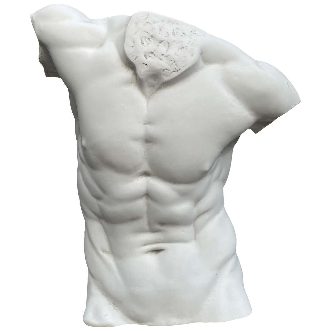 This large male torso statue resembles the classical movement of the famous Laocoön and Belvedere torso in the Vatican Museums. Stunningly well executed, this marble sculpture of a naked male torso has incredible details at the back and front