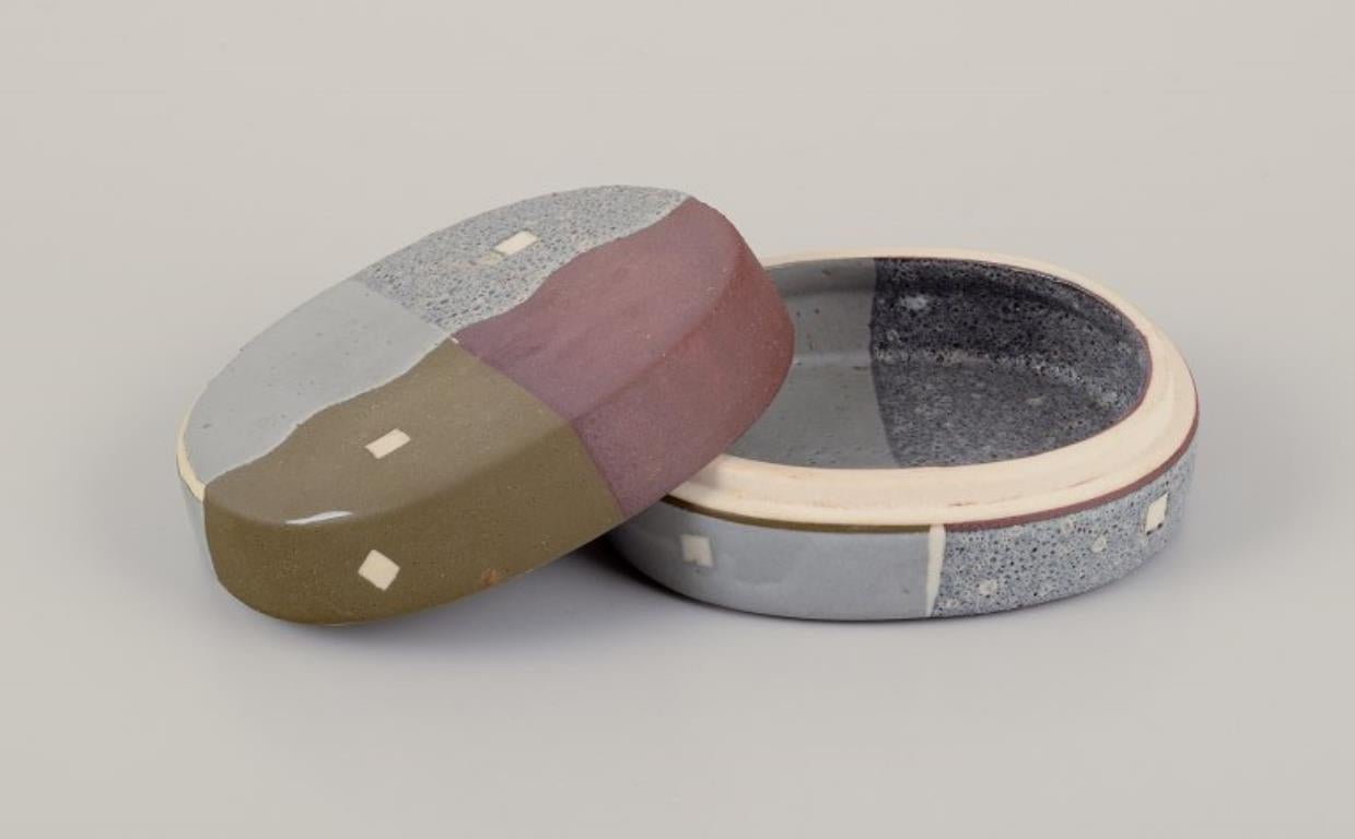 Malene Müllertz (b. 1949), Danish ceramist.
Unique lidded box in ceramics. Hand-decorated in matte and glossy glaze in various colors.
In perfect condition.
Signed and dated '91.
Dimensions: L 10.0 cm. x W 9.0 cm. x 4.0 cm.