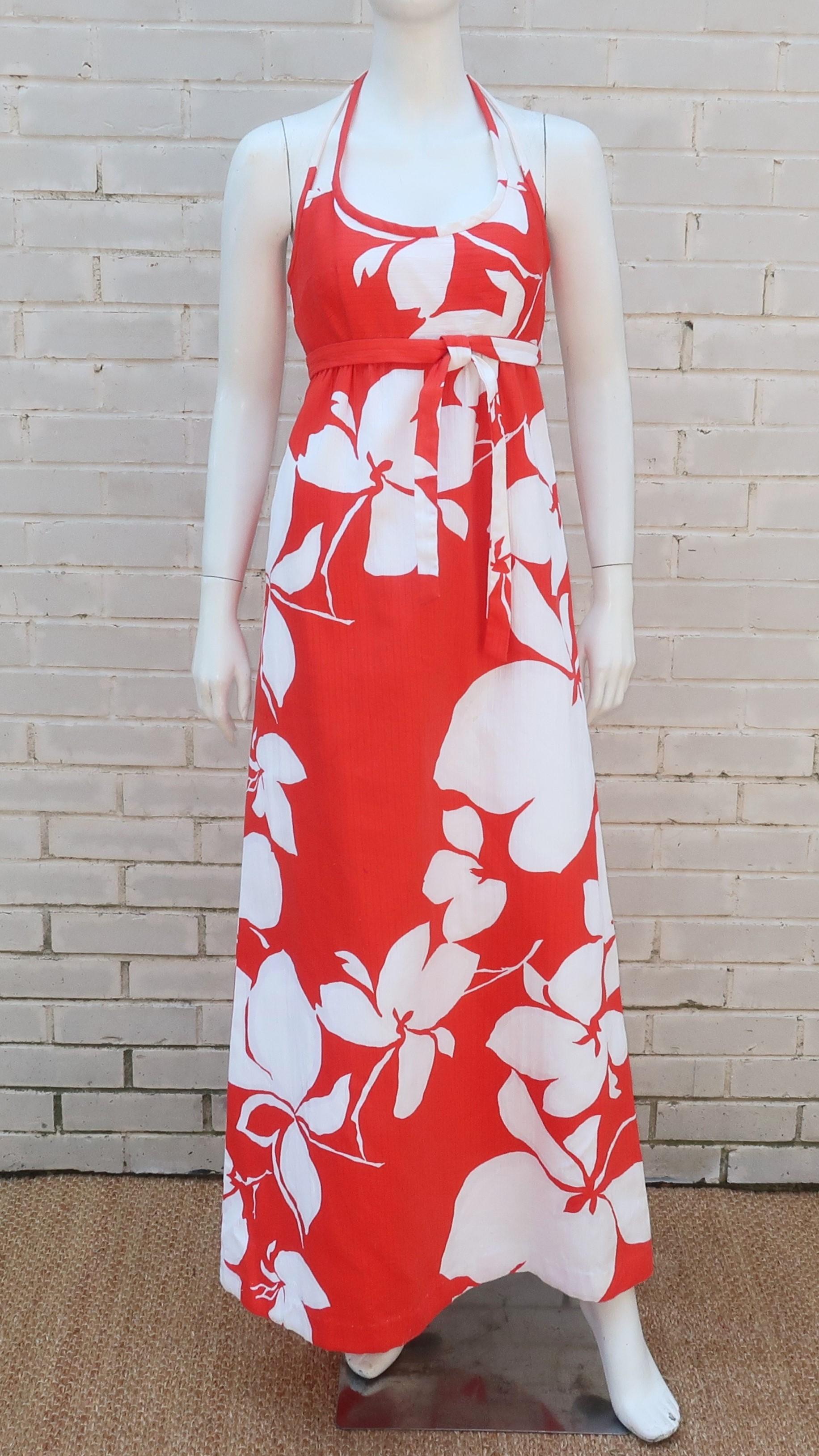 Return to the tropics in this Malia of Honolulu late 1960's abstract floral halter maxi dress in a vibrant color combination of flame red and white.  The heavy cotton fabric has a pique style weave with an empire silhouette accented by double