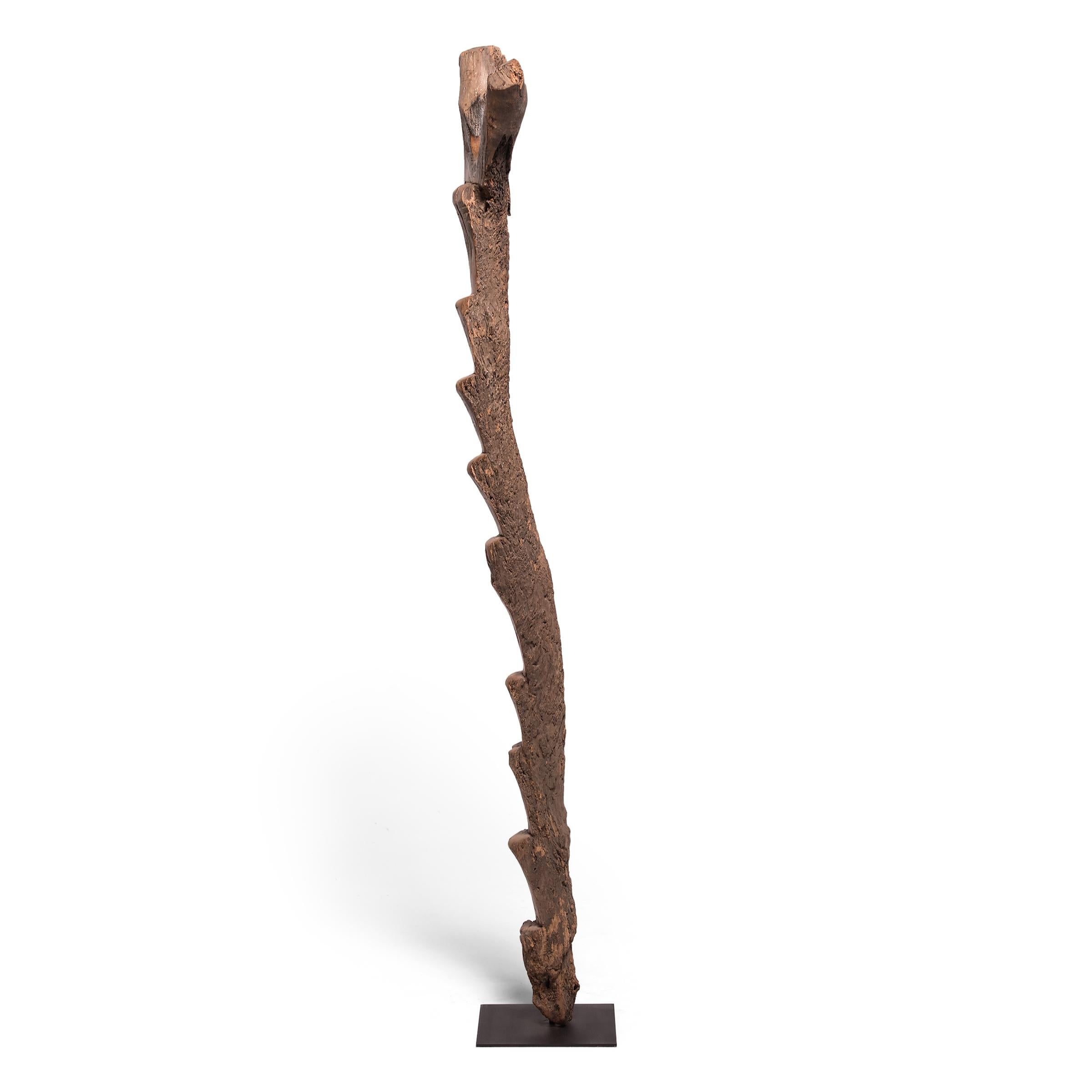 The Dogon people of Mali lived a vertical life. With homes set into cliff faces and orchards to harvest, tree ladders were integral tools of daily life. A pattern of well-worn steps darkens the wood, adding depth and texture, balanced by the