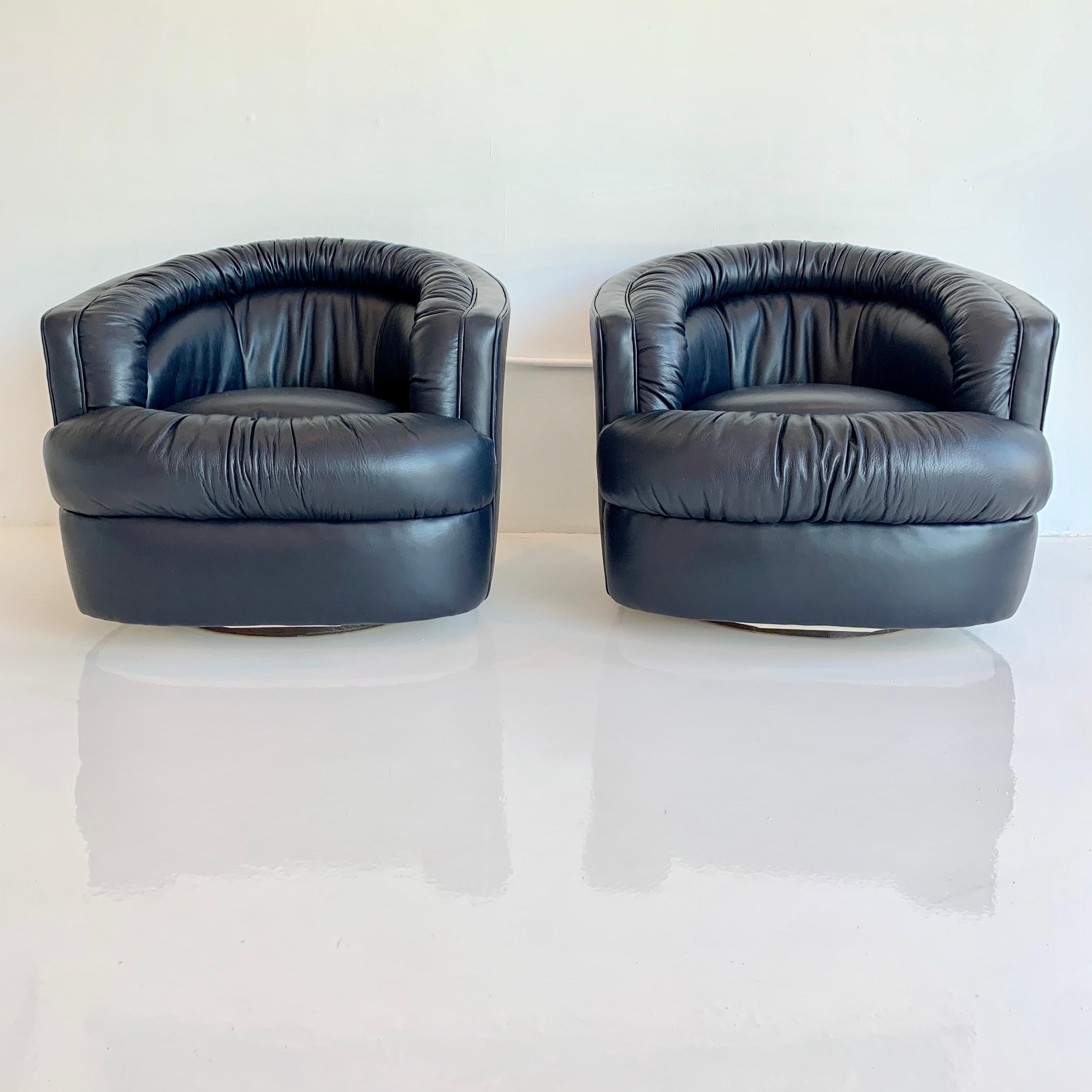 Stunning pair of leather swivel chairs made by Merit, Los Angeles. Round swivel chairs with ruched leather. Perfect scale. Extremely comfortable. Available COM. Lead time 4-5 weeks.