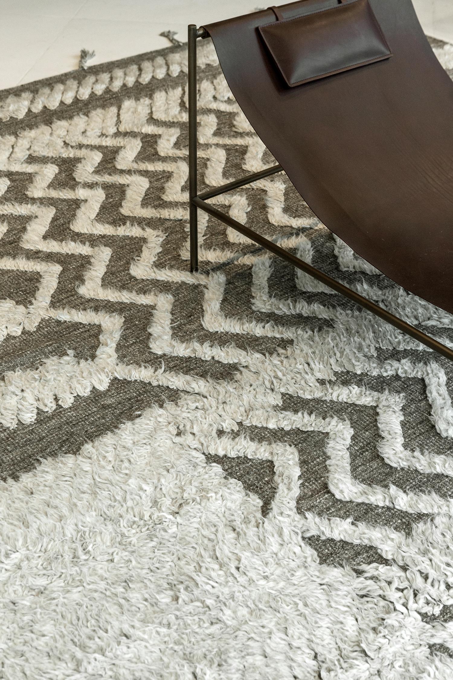 A plain and simple textured Malibu rug from Zig Zig Zag collection that features a diagonal pile weave strokes. This phenomenal work of art gives the inspiration to enhance your contemporary interiors. An ash and charcoal tone that gives extra to