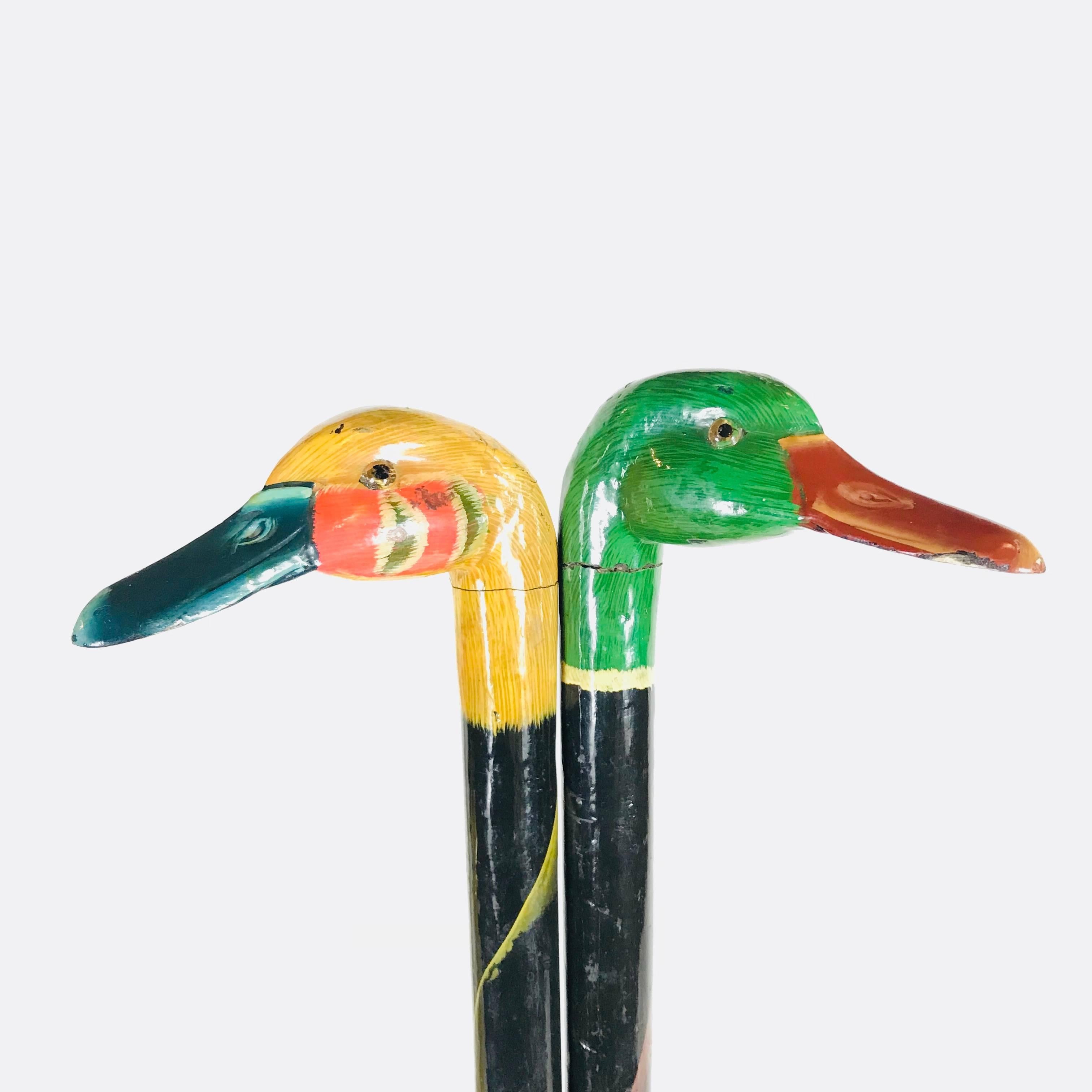 Pair of fine hand-painted duck head walking canes from 1950s England, the walking sticks are from a French collector. His collection included more than 500 canes. Very decorative items for a shop.

Measures: 
Stick length: 84 cm / 33 in.
Material:
