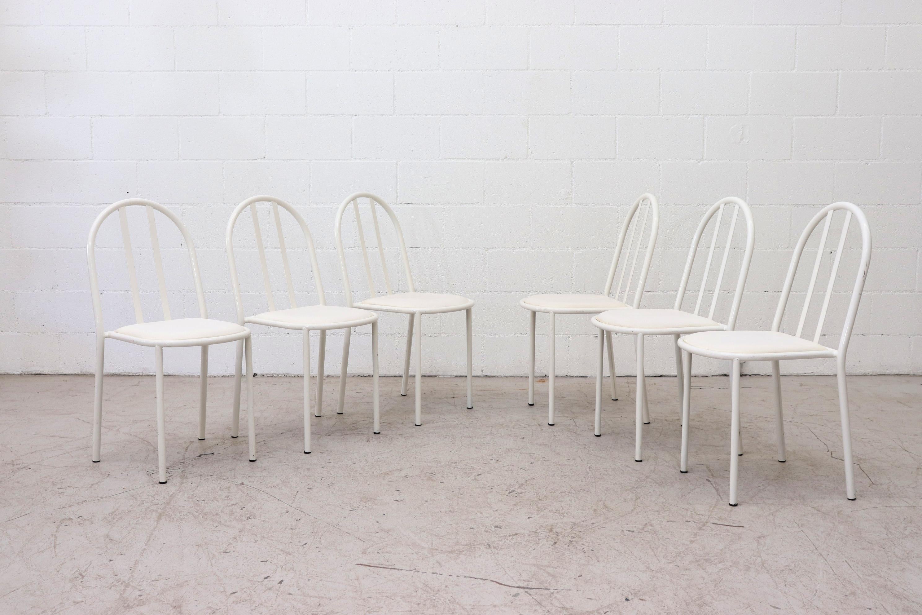 Mod Mallet Stevens and Thonet style white enameled metal stacking chairs with white vinyl seat cushion. In original condition with visible wear. Some of the seating may have small tears. Wear is consistent with their age and use. Lead time from time