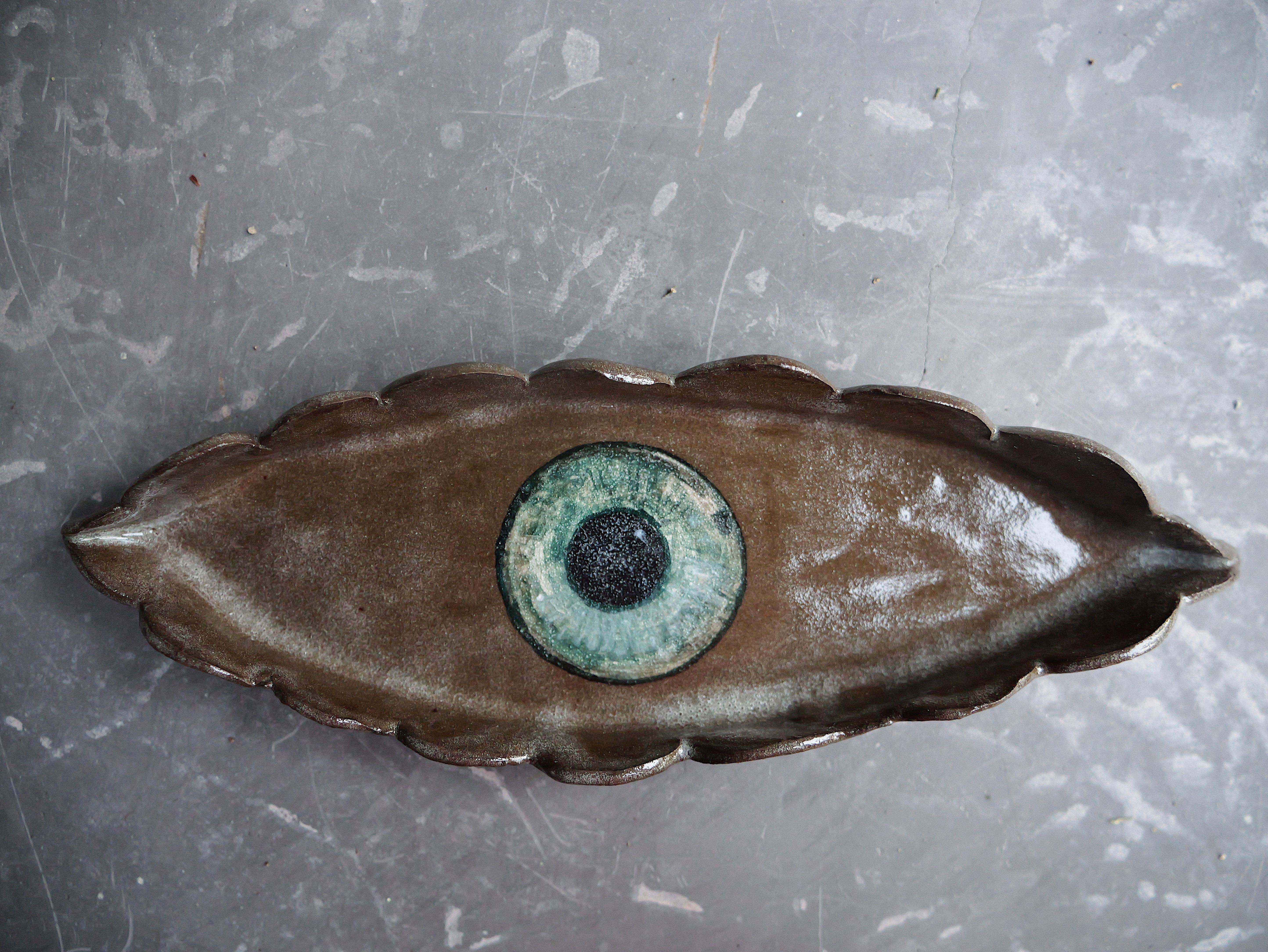 A one of a kind set of three, hand sculpted 'Malocchio' Evil-eye Catch-Alls. The richly hued irises, painted with layers of blue, green, and chestnut glazes really pop against the chocolate brown earthenware background. Hand-pinched scalloped  edge,