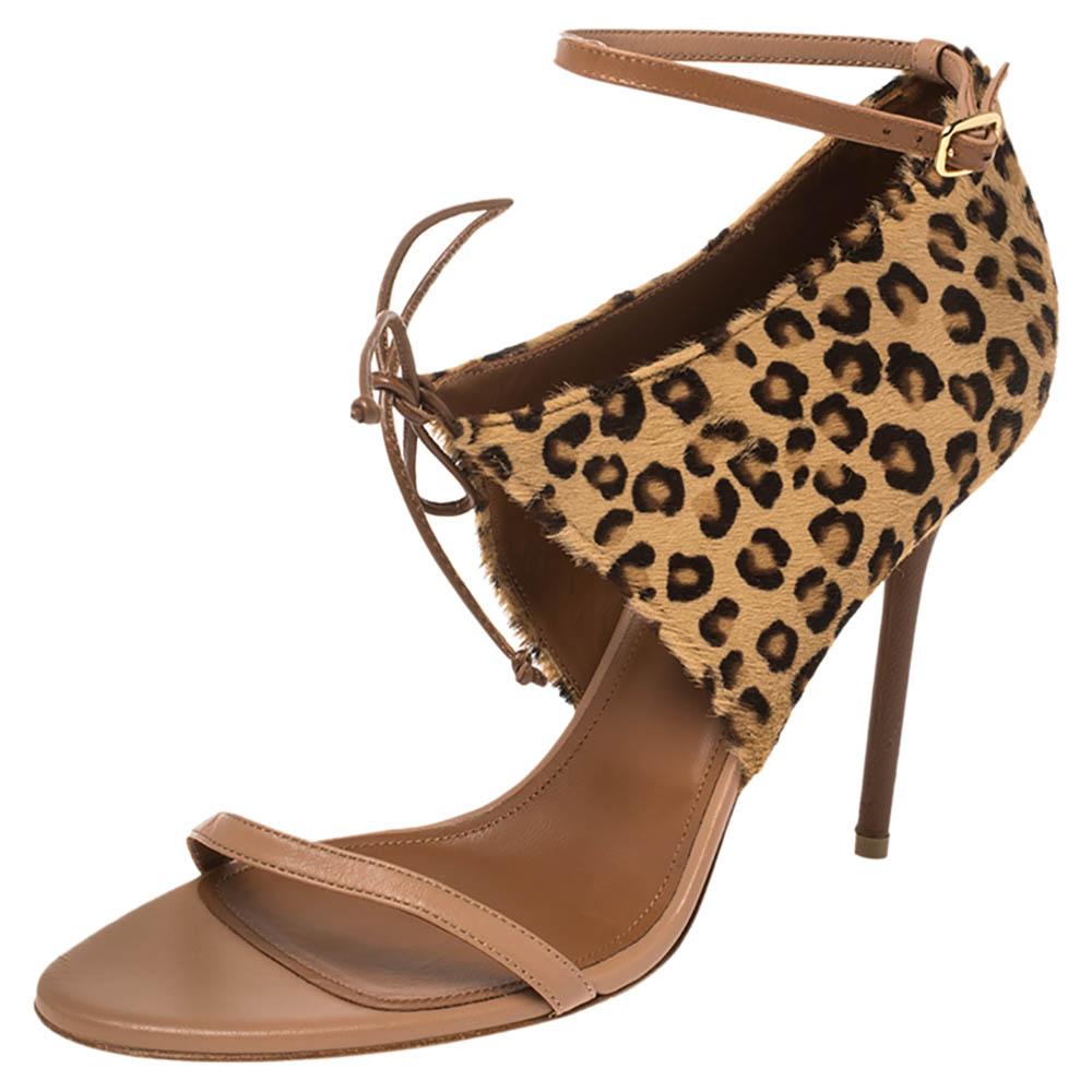 These stunning sandals by Malone Souliers are crafted from leopard print calfhair panels that cover the counters and side panels and are tied with strings into dainty bows. They also feature slender leather straps on the uppers and ankles. These