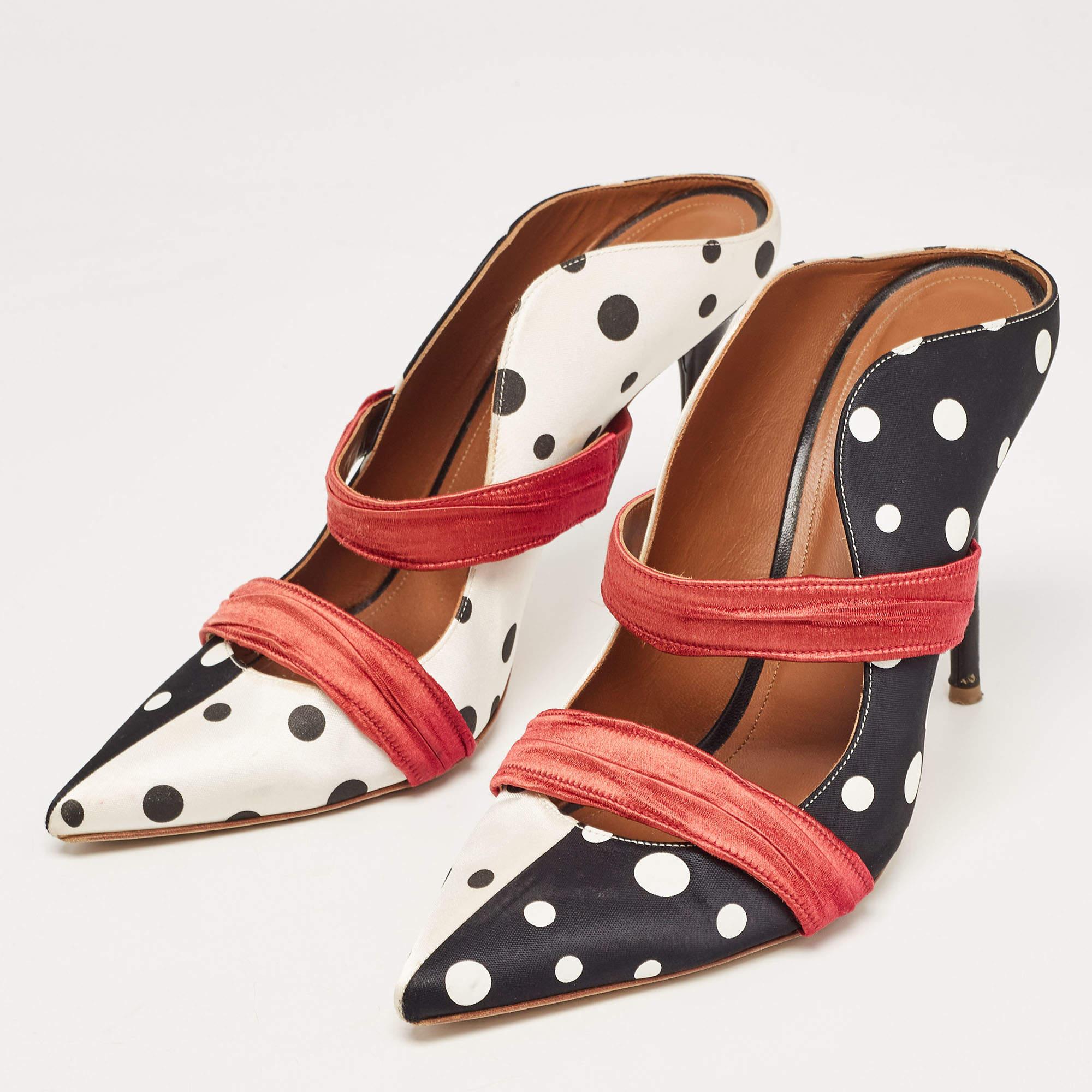 Admired for its waved silhouette, this pair of Malone Souliers mules will make sure the spotlight follows you everywhere. The contrast straps detailing across the polka dot exterior enhance its contemporary shape. Created from satin, the 12cm heels