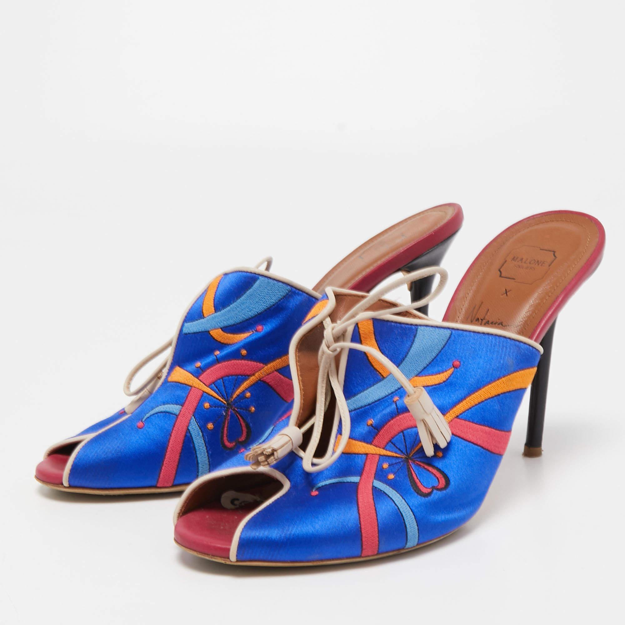 How pretty are these mules from Malone Souliers Fashioned in a striking blue embroidery   these mules are elevated with lace up fastenings on the upper. They are finished with peep toes  slender heels  and a slip on style. Revamp your outfit with