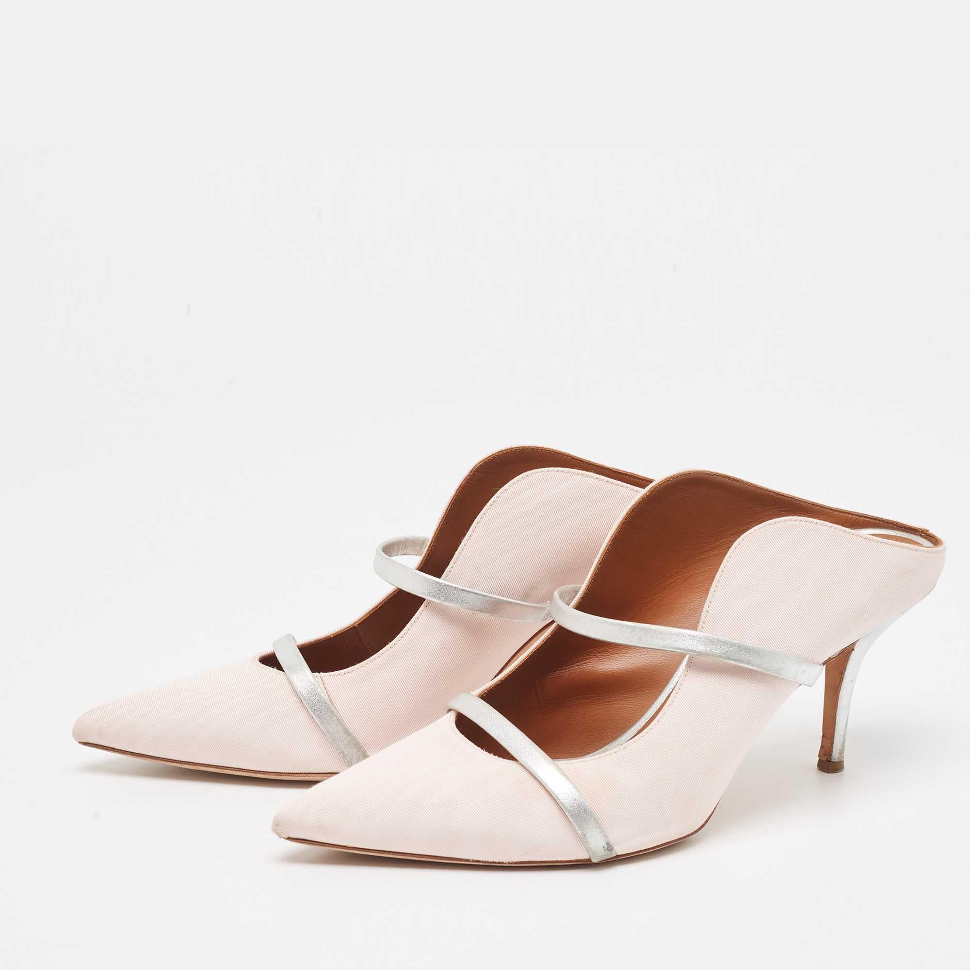 Admired for their waved silhouette, these Malone Souliers mules will make sure the spotlight follows you everywhere. The strap detailing across the upper enhances its contemporary shape. Created from fabric and leather, they are complete with a