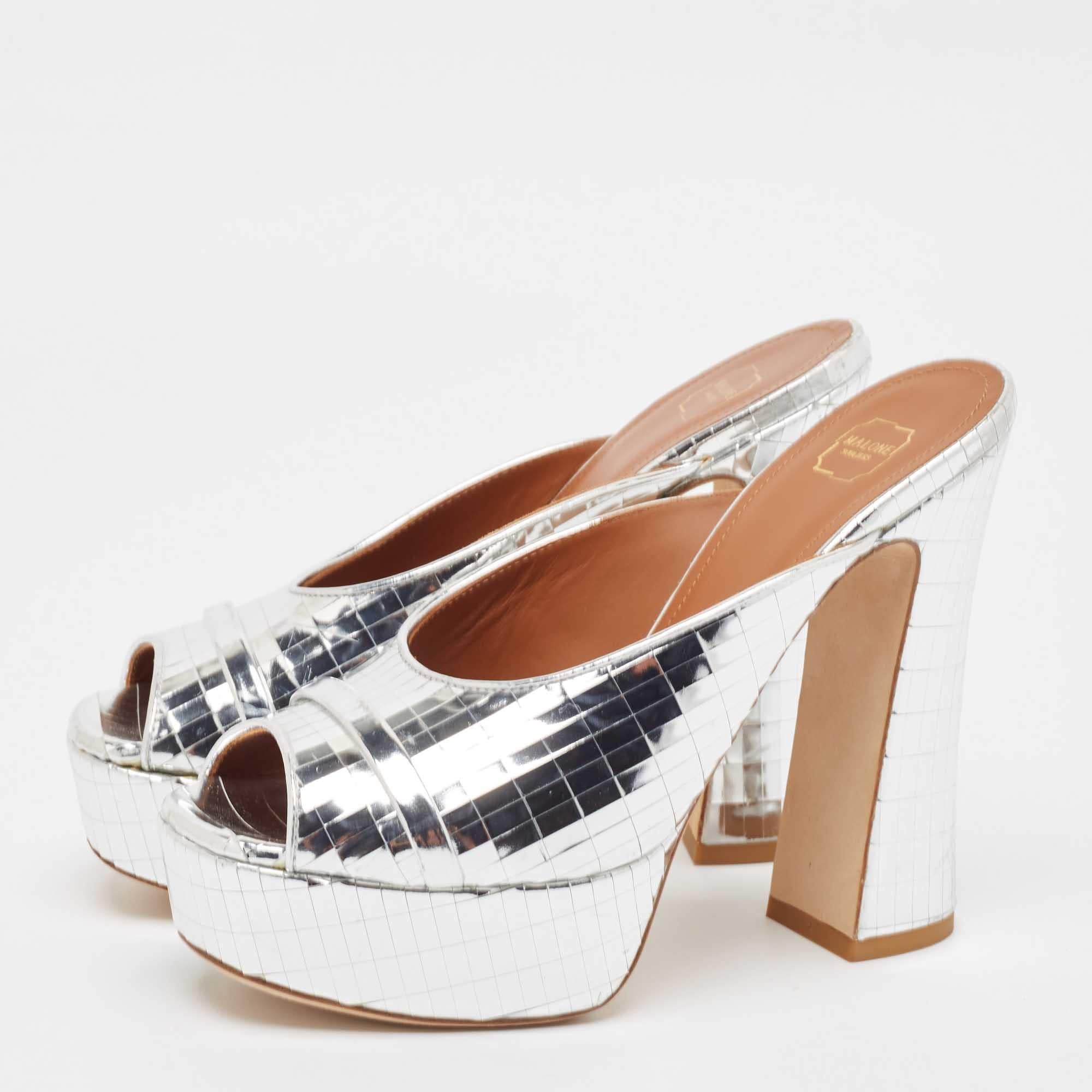 These Malone Souliers slide sandals will offer you both luxury and comfort. Made from quality materials they come in a shimmering silver and are set on 10 cm block heels.