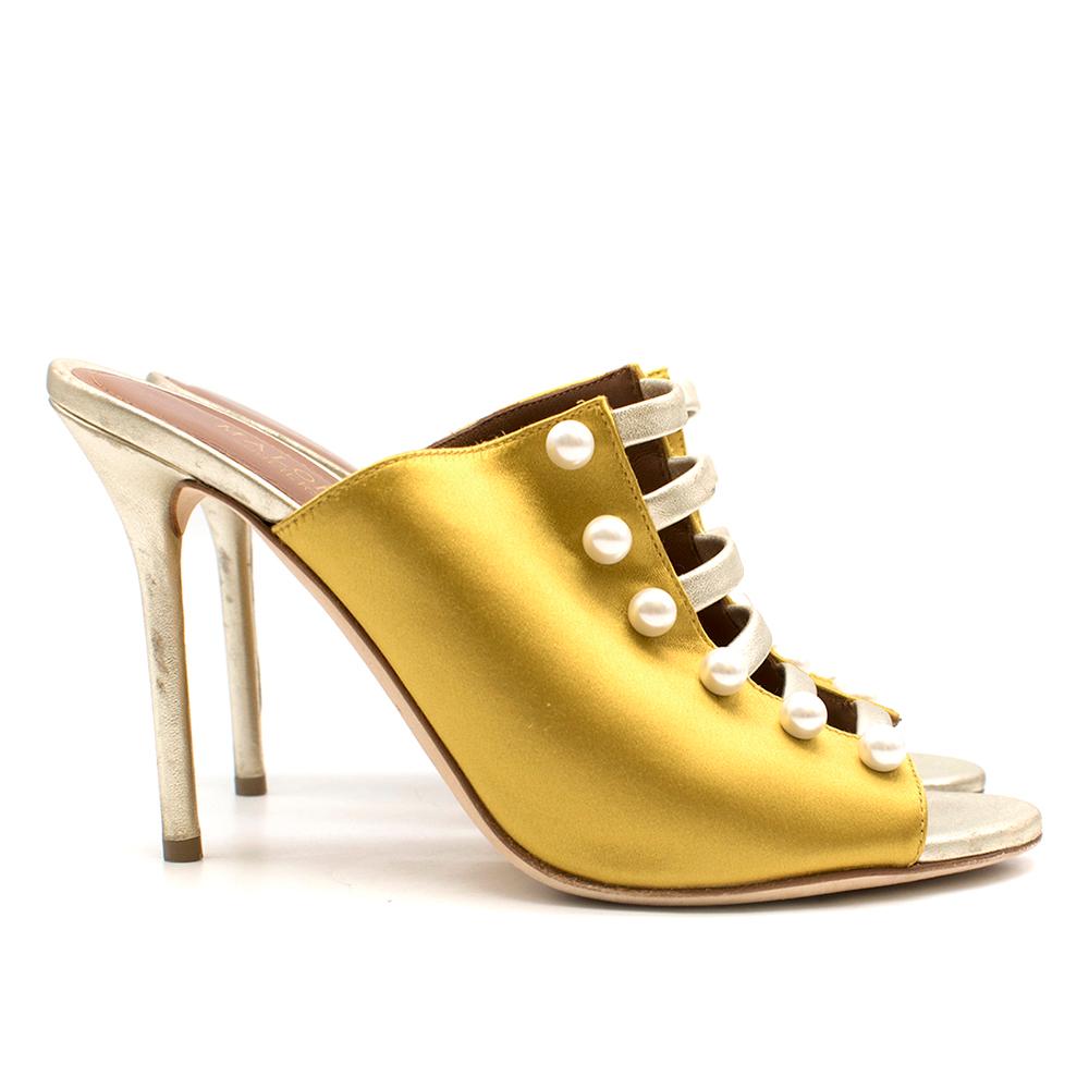Malone Souliers Zada Yellow Mules 100

- Leather strap and pearl inclusions
- Pin-thin stiletto heel
- Leather insole
- Handmade in Italy

Please note, these items are pre-owned and may show some signs of storage, even when unworn and unused. This