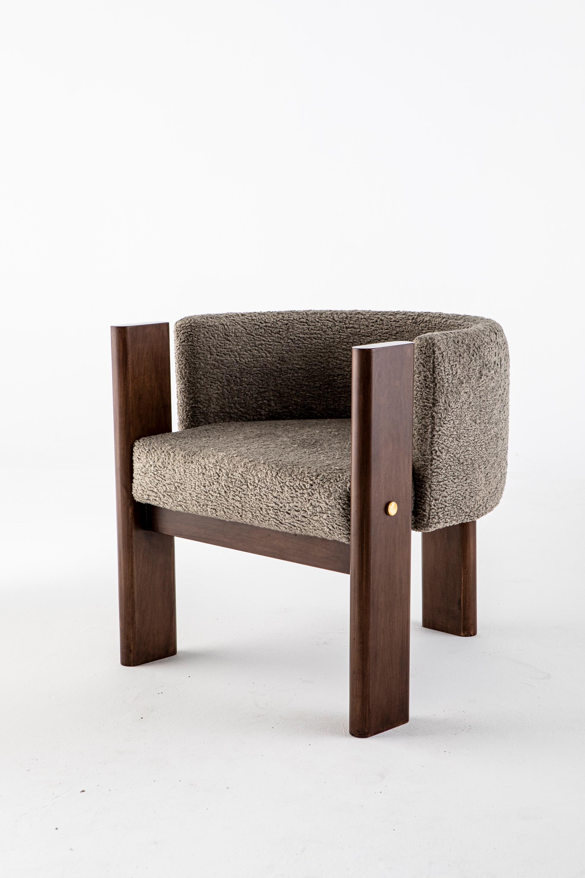 Malta Boucle dining chair by Egg Designs
Dimensions: 70 L X 68 D X 70 H
Materials: Walnut Timber, Brass, Grey Bouche Upholstery

Founded by South Africans and life partners, Greg and Roche Dry - Egg is a unique perspective in contemporary