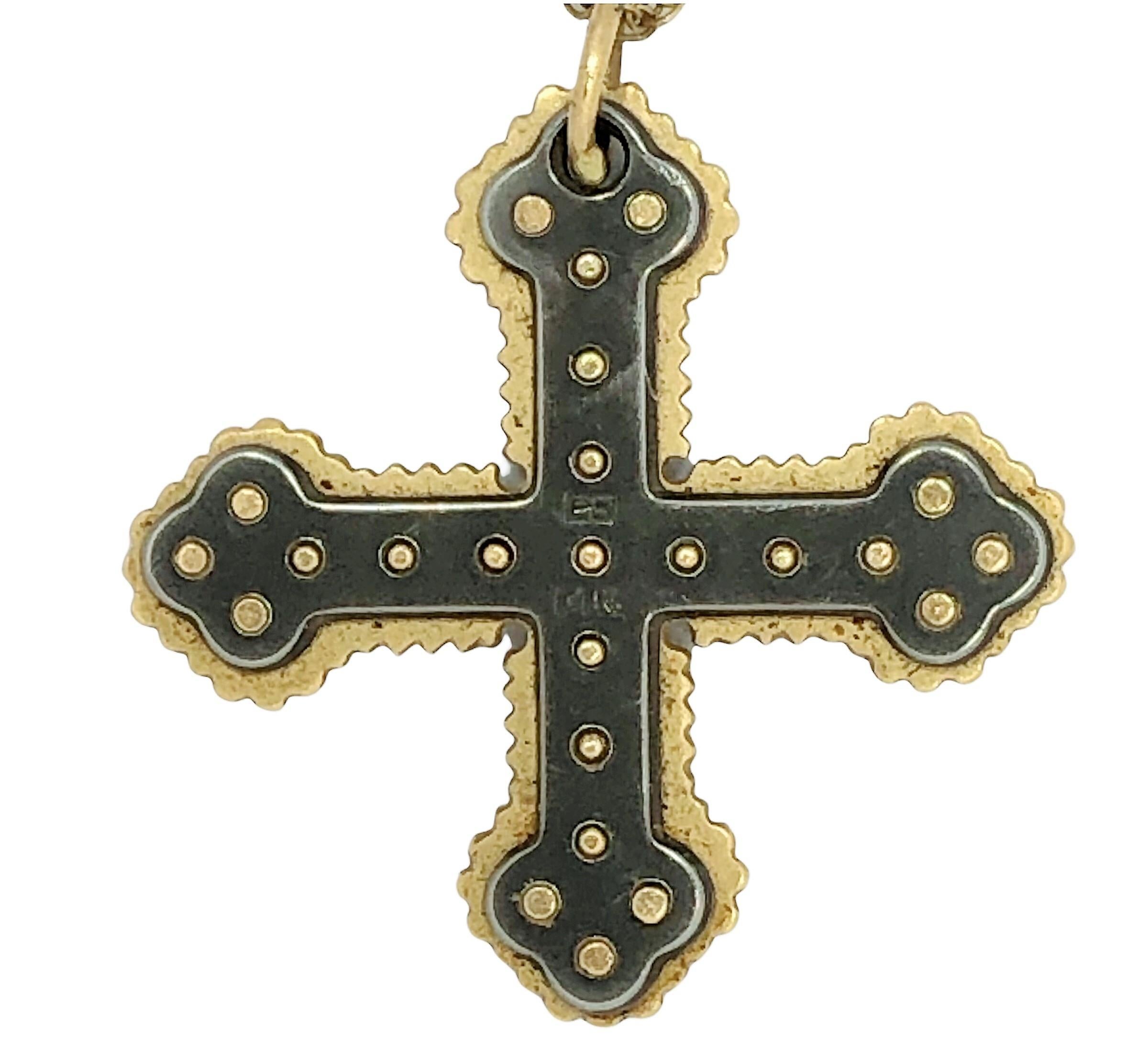 This interesting 14K  Maltese cross has a very Medieval feel and has a strong presence. The gold edges are scalloped and the oxidized surfaces are punctuated with gold beads.  Measures 1 inch in length by 1 inch in width. Marked 14K  