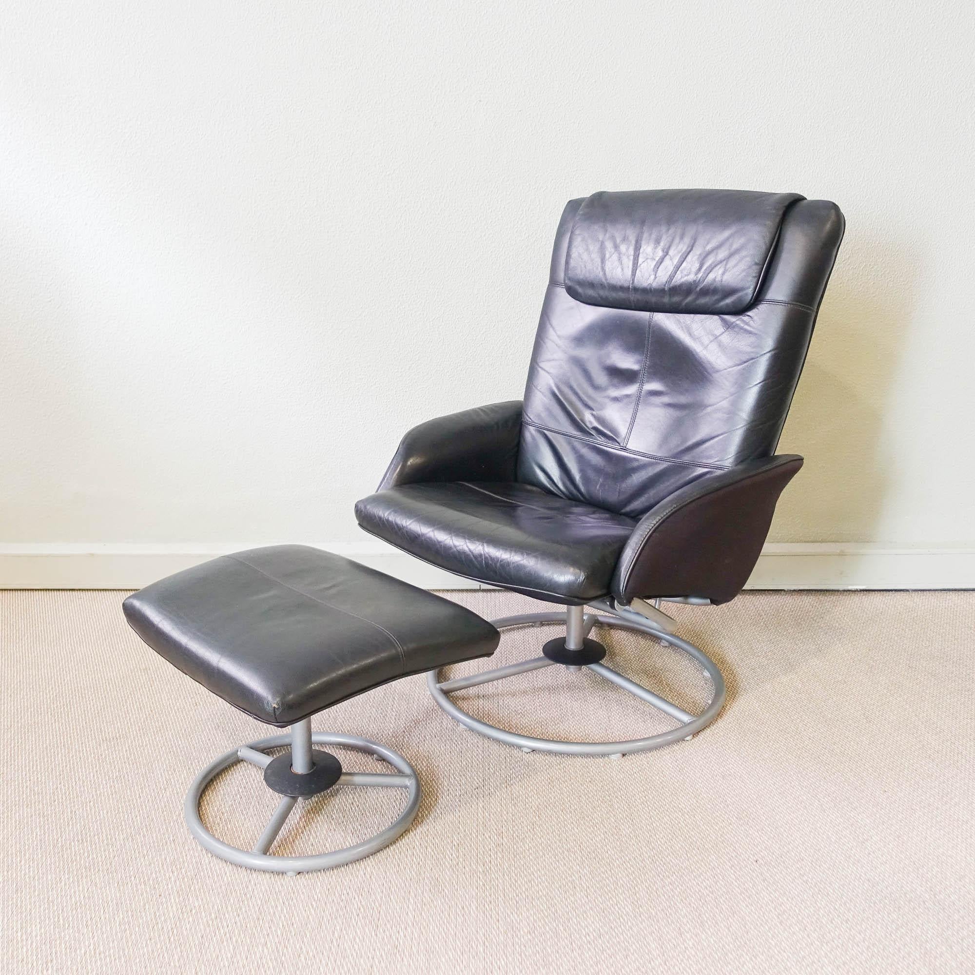 The 'Malung' recliner was designed and produced by Ikea in 1999. The chair and footstool have a circular metal base and are upholstered with a skai in black color. The back of the chair can be reclined. Used, but still in good condition, they