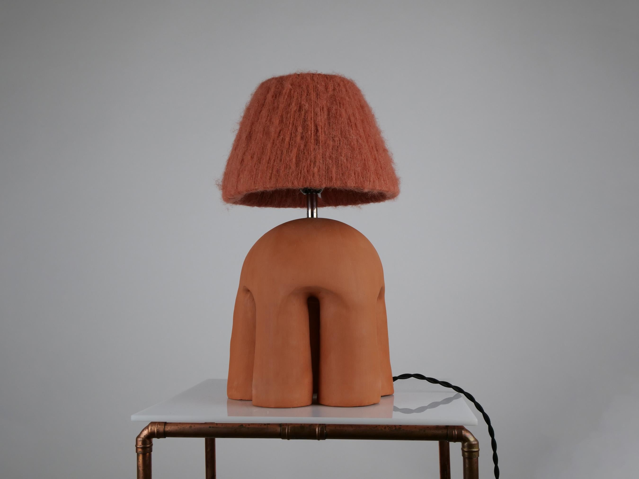 The Malvern lamp is a hand-built ceramic lamp inspired by the Malvern Hills in the UK. The texture of the alpaca silk lampshade contrasts to the hard surface of the terracotta yet they create a perfect balance. Each lamp is unique and has its own