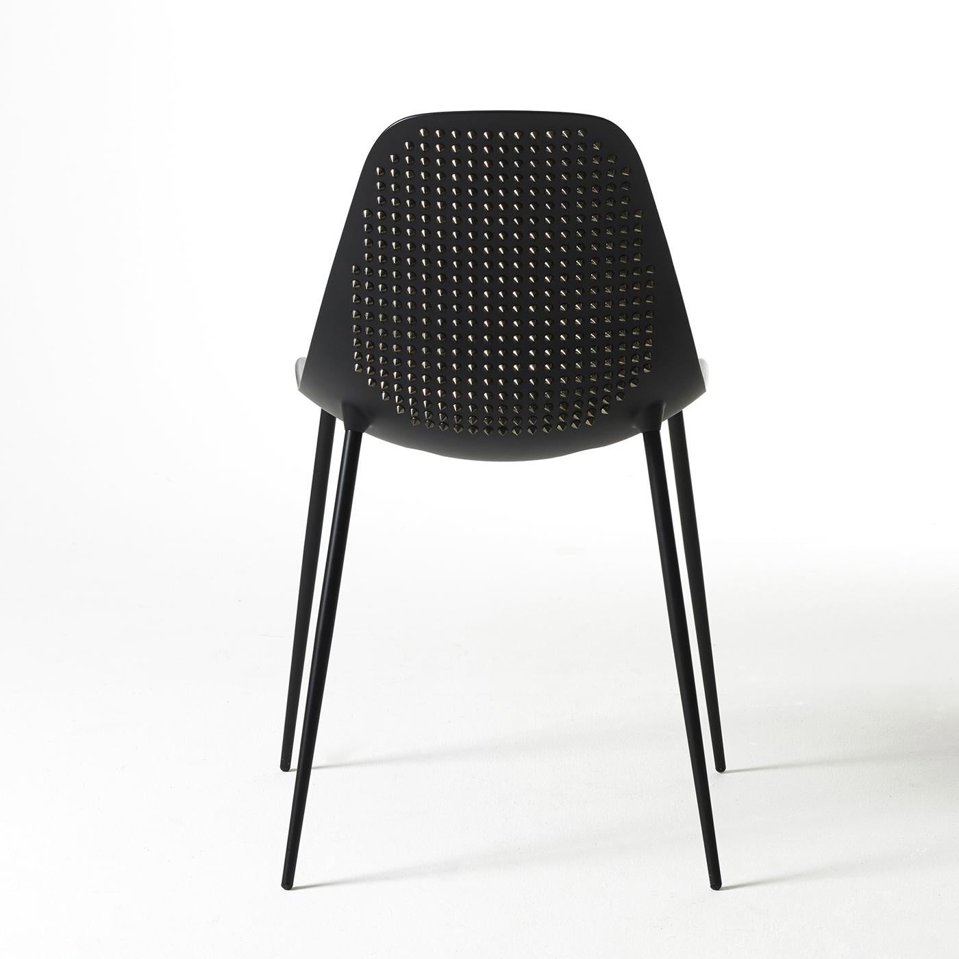 This striking chair has a structural skin in aluminum supported by a zinc-coated metal structure. The chair is hand-finished in matte black and accented by hand-applied metal chromed studs to that give a unique texture to its outside surface.