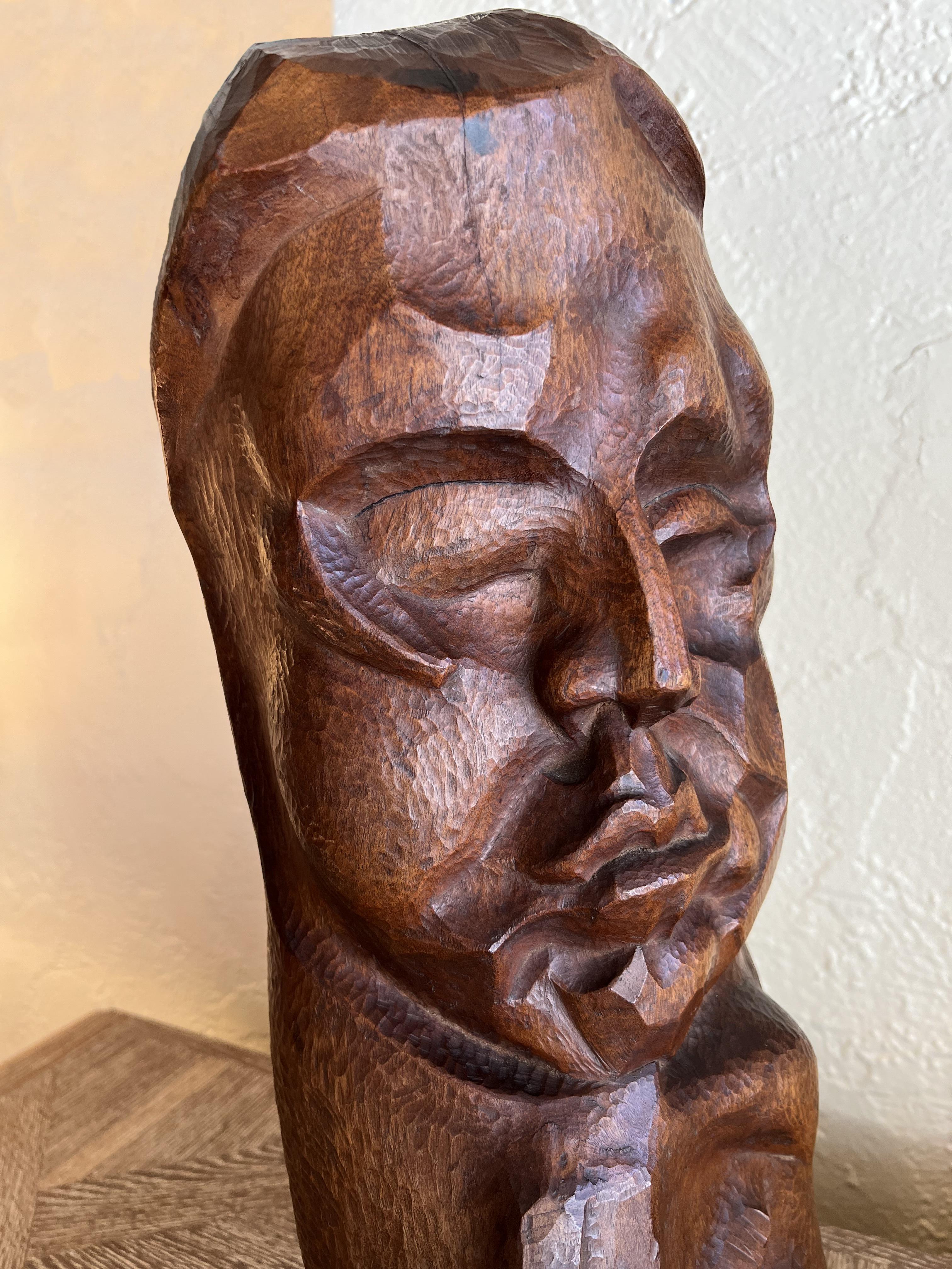 Strong sculpture in walnut featuring a male bust.