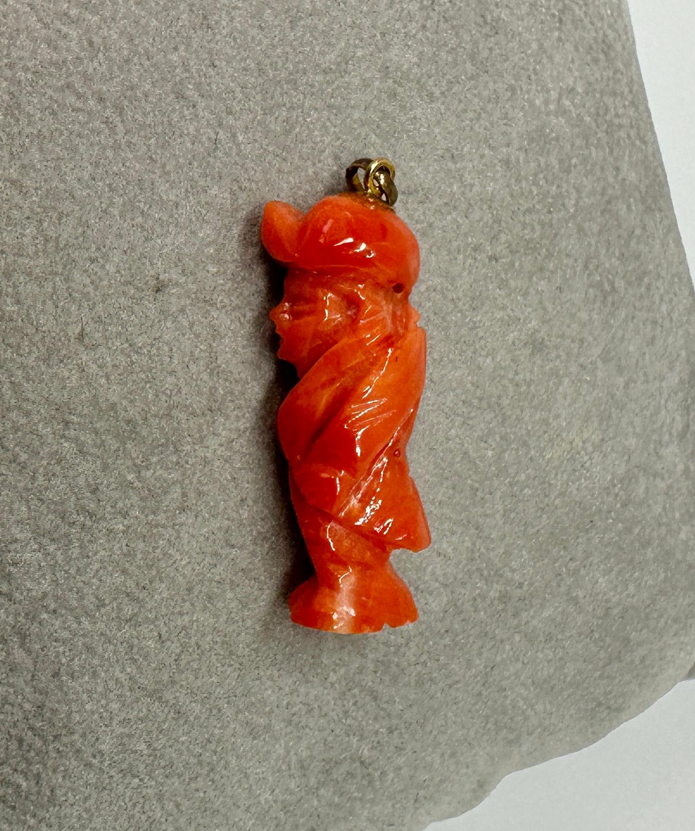 This is a stunning antique Art Deco Pendant or Charm of a Man In a Hat in gorgeous hand carved natural Coral and set in 18 Karat Yellow Gold.  The coral gentleman pendant or charm is a masterpiece of artistic expression - the man is carved with