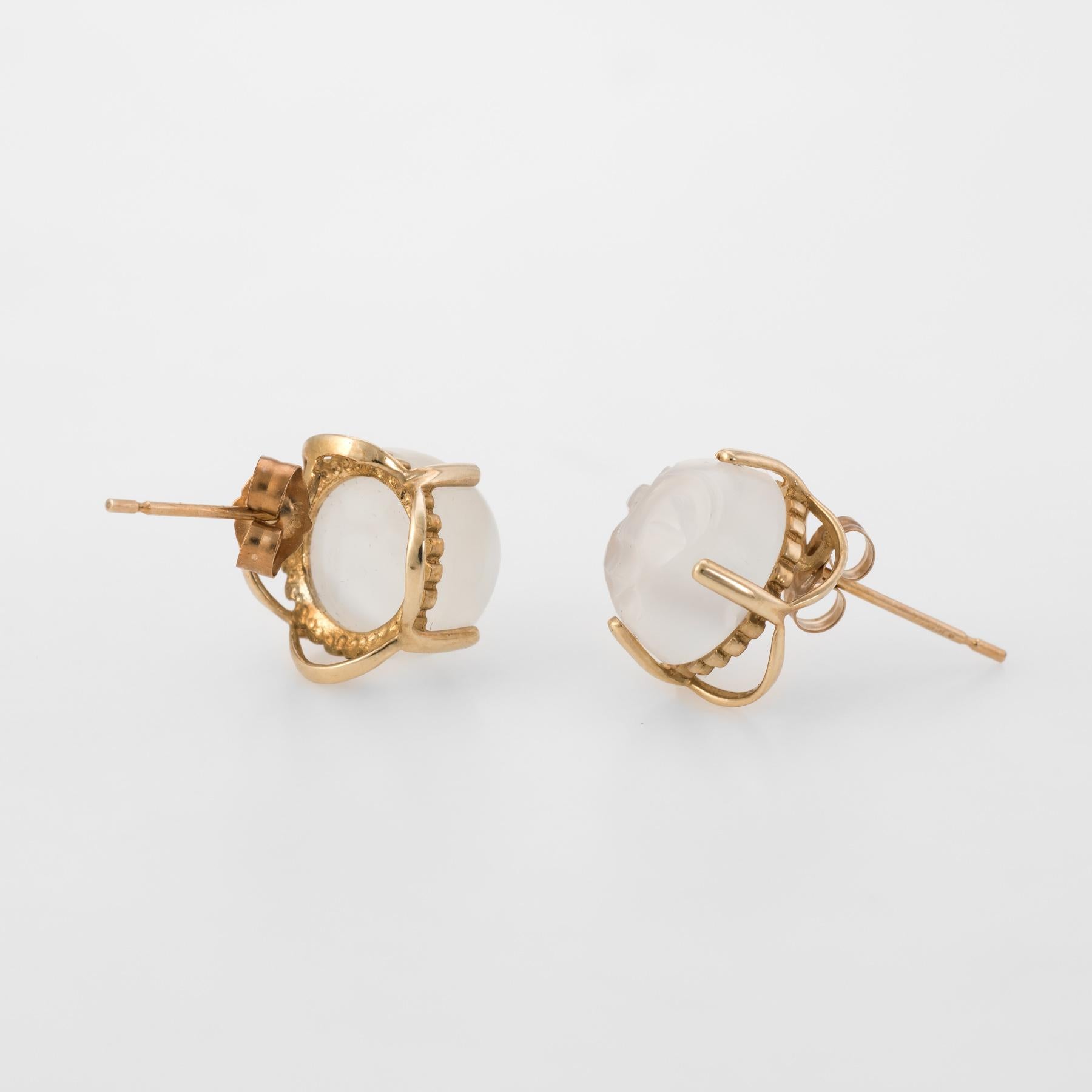 Striking Man in the Moon earrings (circa 1960s to 1970s), crafted in 10 karat yellow gold. 

Centrally mounted iridescent carved moonstone faces each measure 10mm. The moonstone is in excellent condition and free of cracks or chips.   

The matching