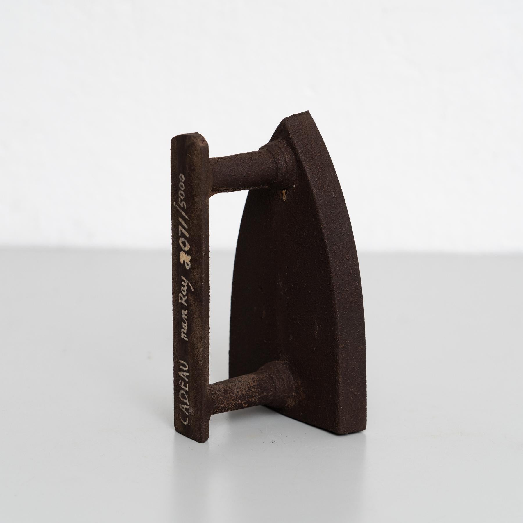Own an iconic piece of surrealist art with Man Ray's Le Cadeau, a striking sculpture produced in 1974 in Italy. This limited-edition work is numbered 2071/5000 and signed by the artist, making it a highly collectible and rare item.

Accompanied by