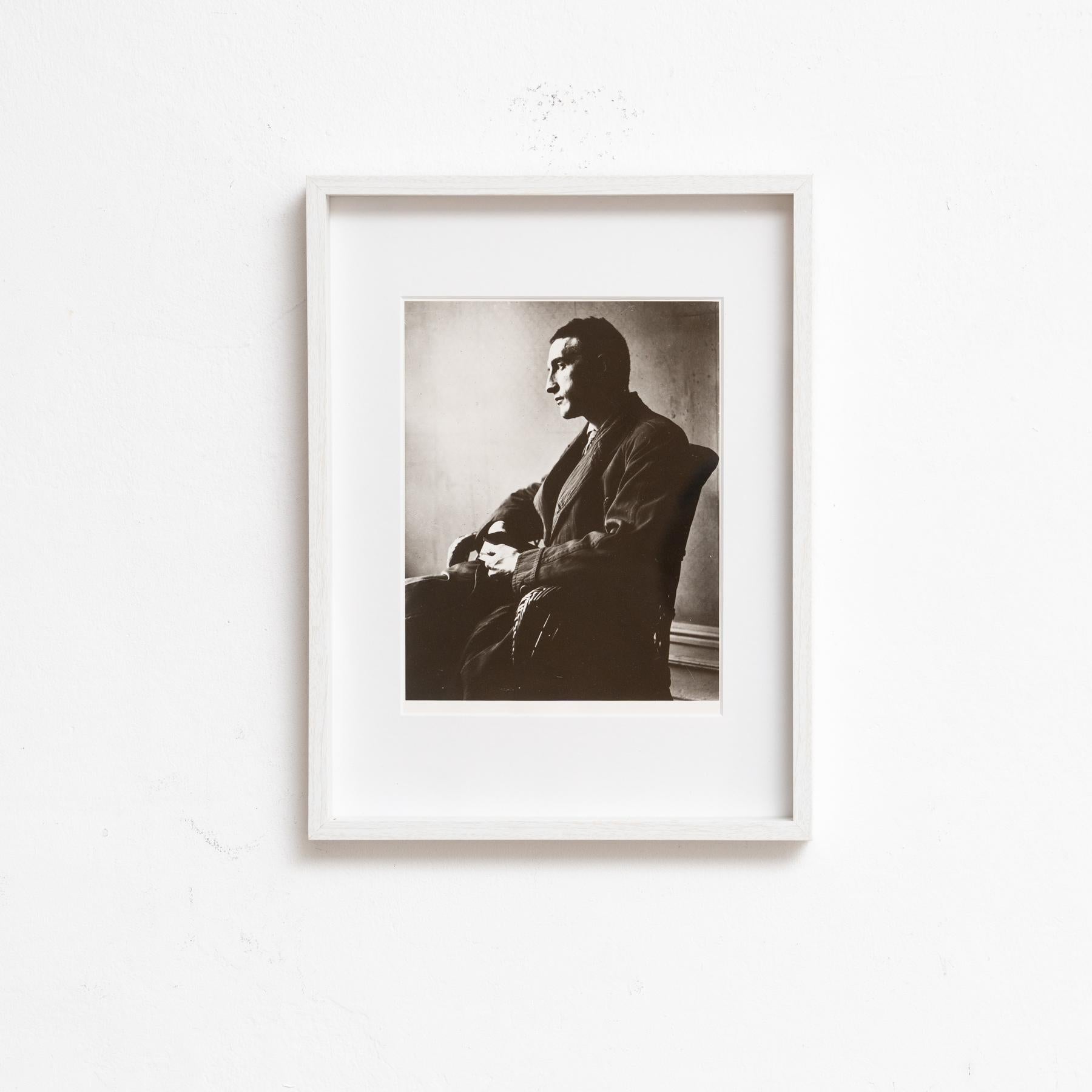 This striking black and white photograph by Man Ray, titled Portrait of Marcel Duchamp, captures the renowned artist Marcel Duchamp in a full-length seated pose. The photograph, originally taken in 1916 and reissued in 1991, is a remarkable example