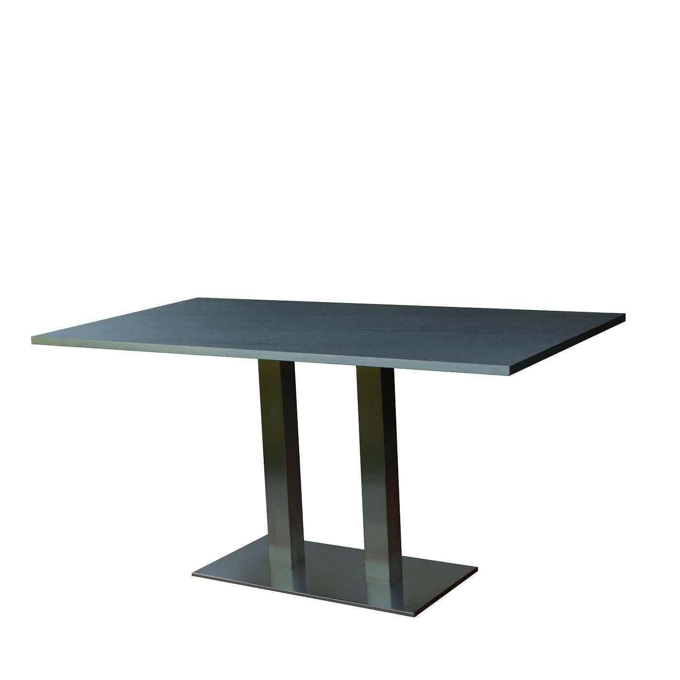 This striking table will be a statement piece for a contemporary decor, thanks to its Minimalist Silhouette and the materials used to craft it. The structure is of steel with a satin finish and comprises a rectangular base with two legs. The top is