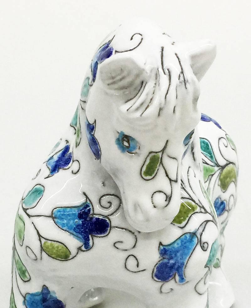 Mancioli Italian Pottery Horse, Figure, Sculpture for Raymor, Florence, 1960s

A Mancioli Italian pottery white horse figurine for Raymor, Florence, 1960s.
The horse is made with thick withe and glazed pottery with blue and green leaf pattern . 
A