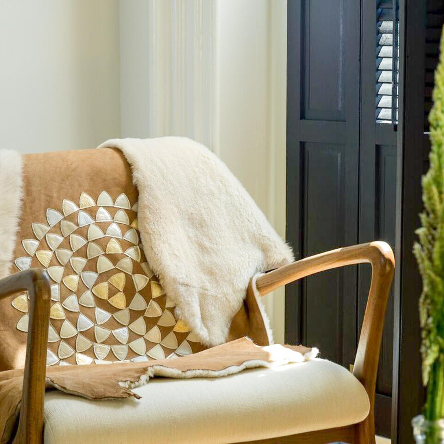 Shearling adorned with hand-punched and sewn metallic appliqué, this full sheepskin hide can be used as a throw, rug or decorative detail anywhere in your home.
Designed to be reversible, on one side are leather accents and the other shows the