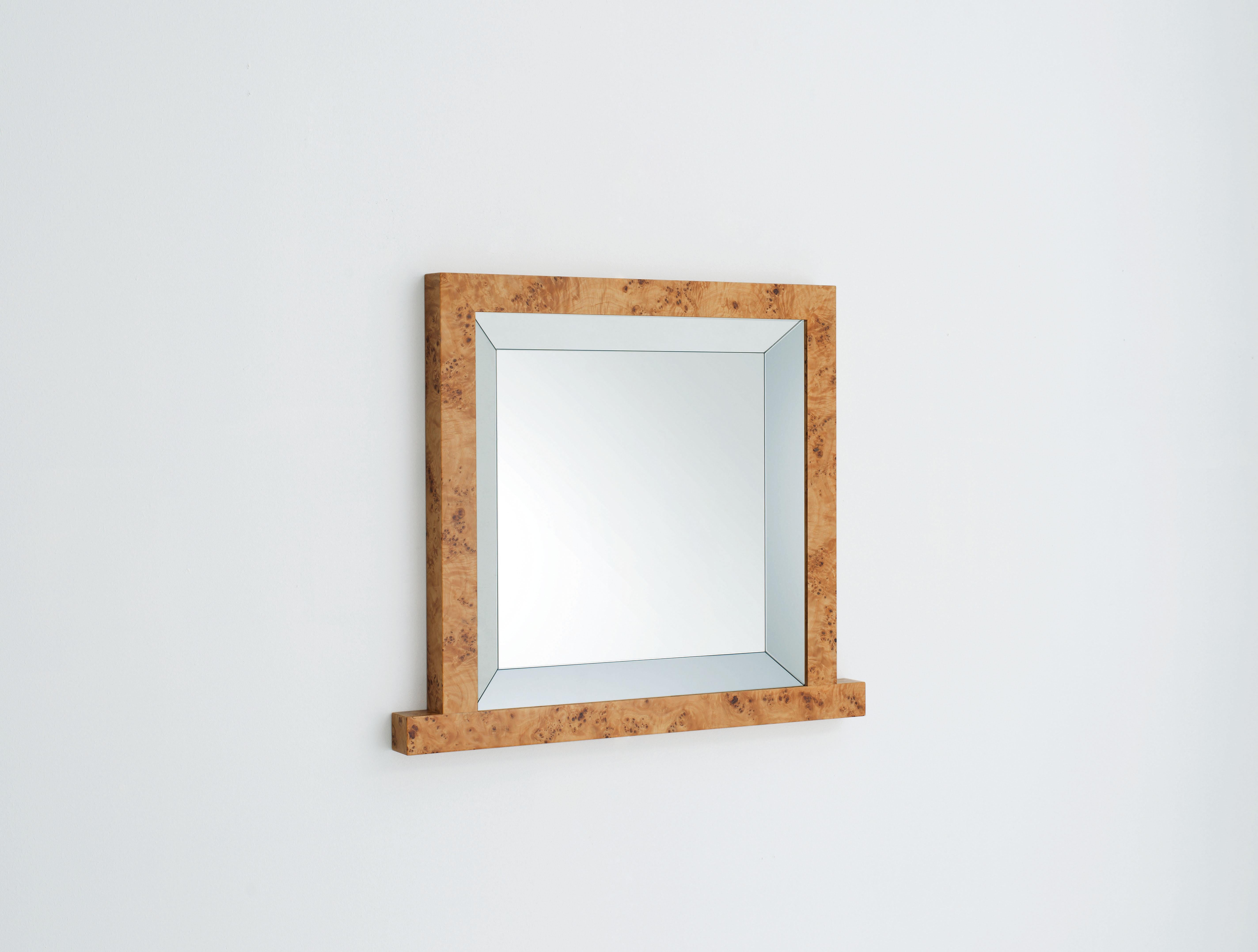 Framed mirror with a reflecting bordering which gives depth. The mirror is inserted in a poplar brier wooden frame.

Ettore Sottsass was born in Innsbruck, Austria, in 1917. He received his degree in architecture from the Turin Polytechnic in 1939.
