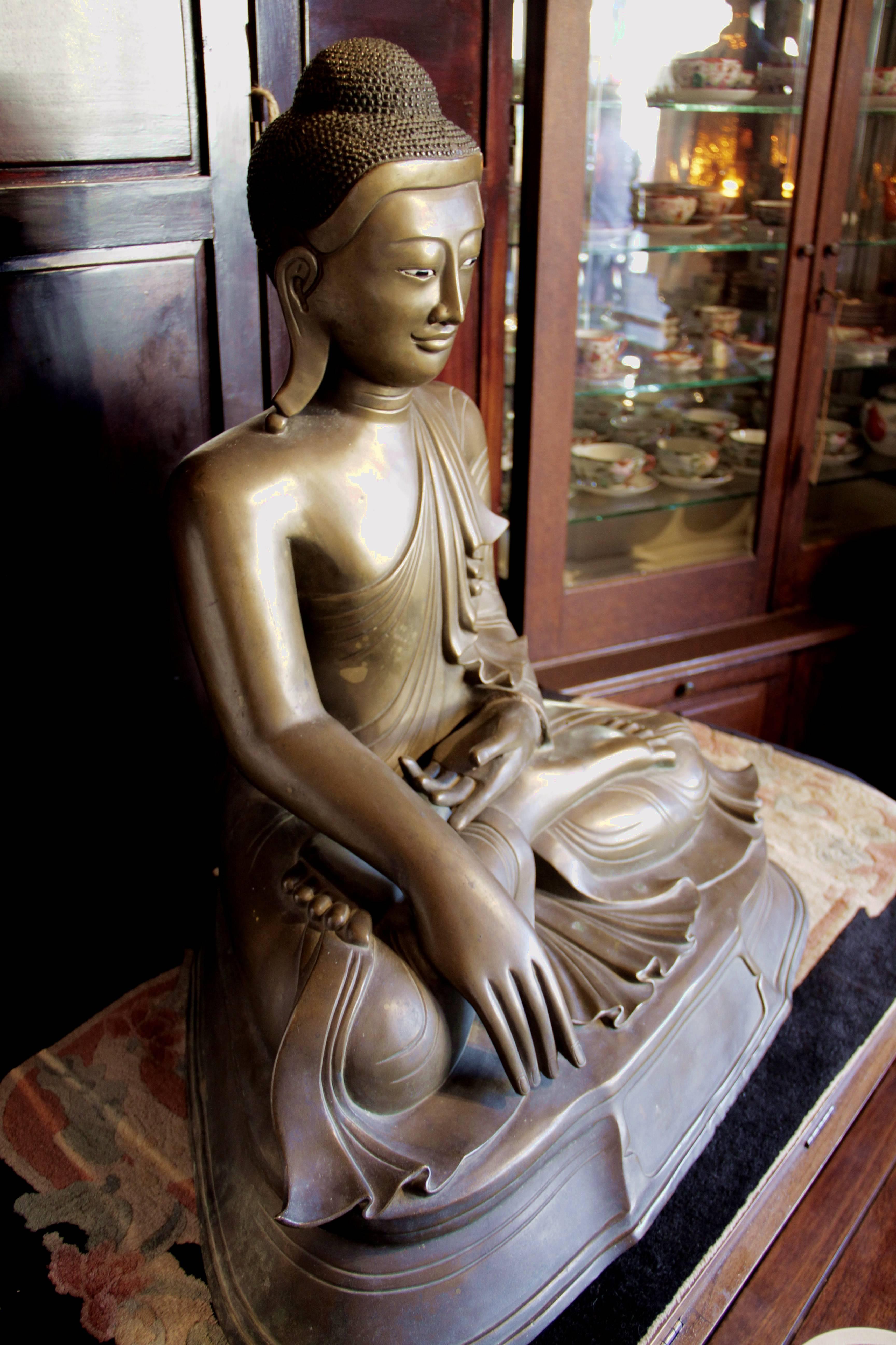 This seated Buddha statue is a Mandalay Buddha made of bronze. It is from Burma, circa 19th century.
Measures: 29 H x 31 W x 18 D.