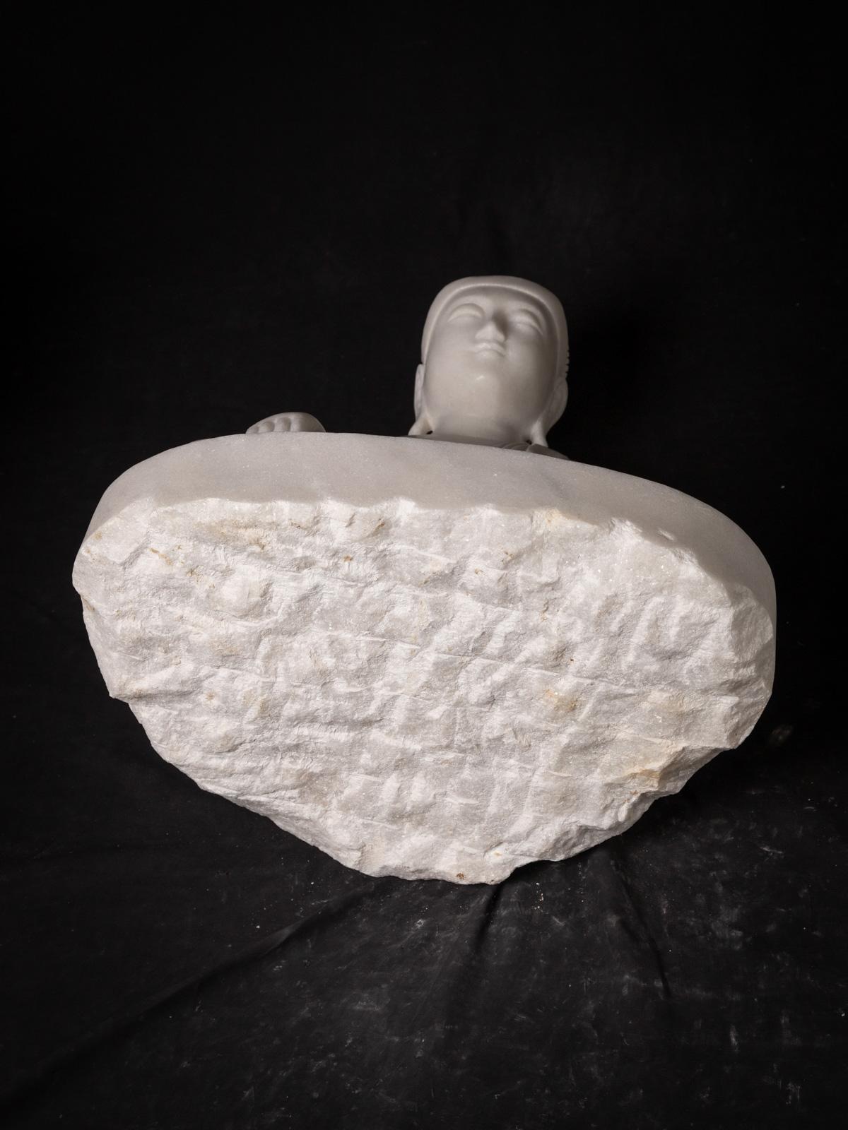 The newly made Burmese marble Buddha statue is a remarkable piece of art, handcrafted from a single block of white marble. Standing at a height of 59.5 cm, with a width of 47 cm and a depth of 34.5 cm, it exudes a sense of grandeur and elegance.