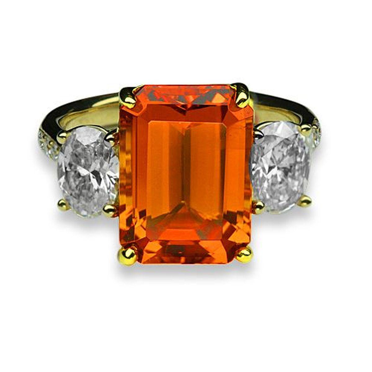 Simply Beautiful! Finely detailed Art Deco Revival 3-Stone Gold Ring. Centering a securely nestled Hand set Emerald-Cut Vivid Orange Mandarin Garnet, VS, weighing approx. 6.64 Carats with a Diamond D-VS on either side; approx. 1.18tcw. The ring is