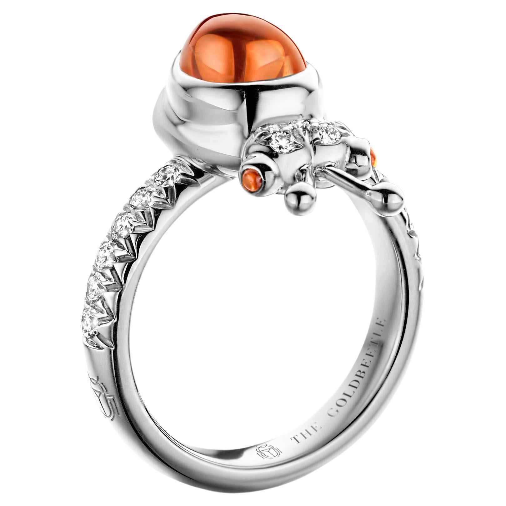 One-of-a-kind lucky beetle ring in 18-karat white gold 8,6 g set with the finest diamonds in brilliant cut 0,34 carat (VVS/DEF quality) one natural, mandarin garnet in pear cabochon cut and two pink tourmalines in round cabochon cut.

Celine
