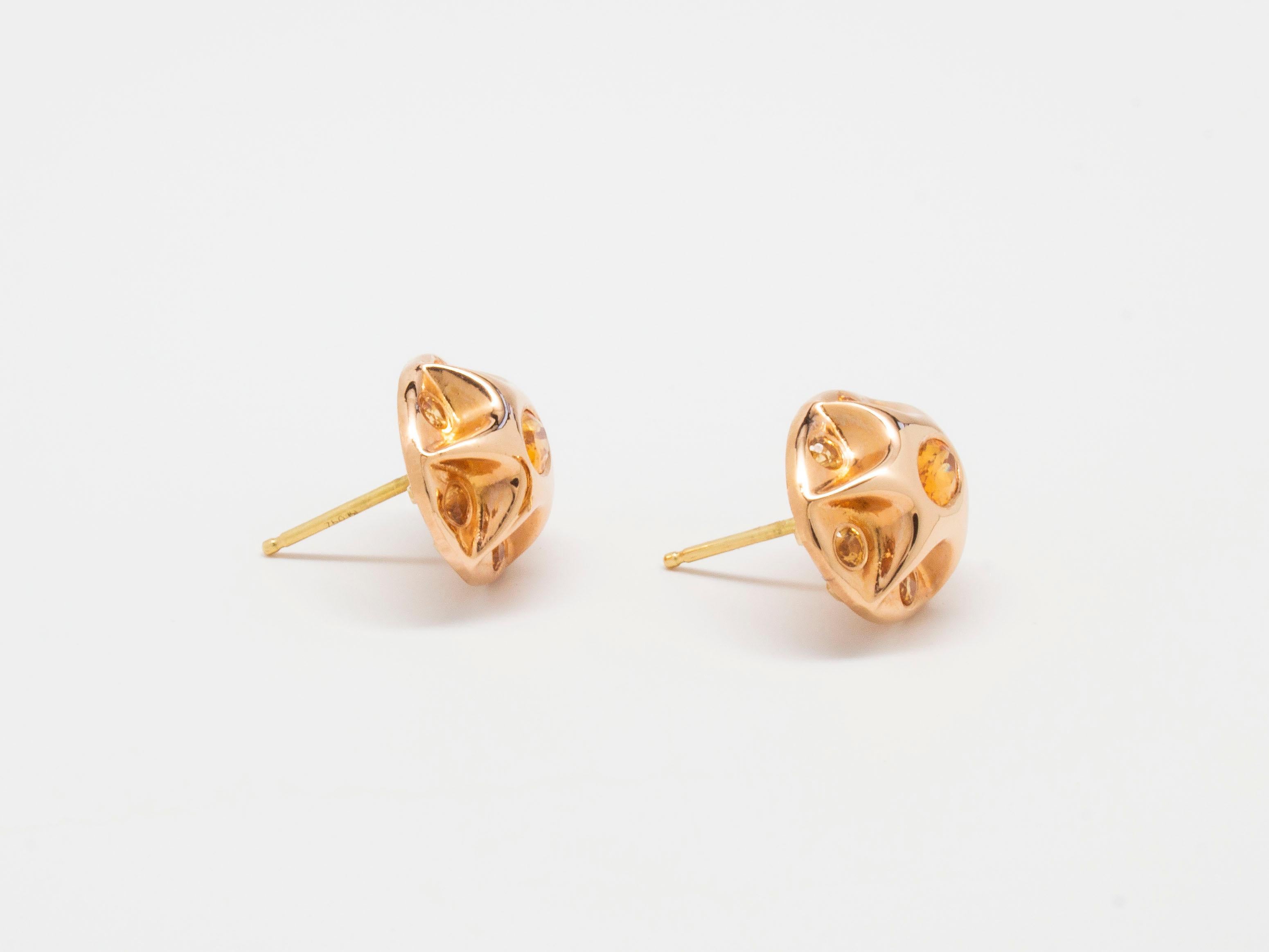 The Sagan Stud Earrings with Mandarin Garnet from modern fine jewelry house, Baker & Black. Electric garnets the color of tangerines are paired with rose gold in these 1950's style button earrings featuring Baker & Black's signature astral shape.