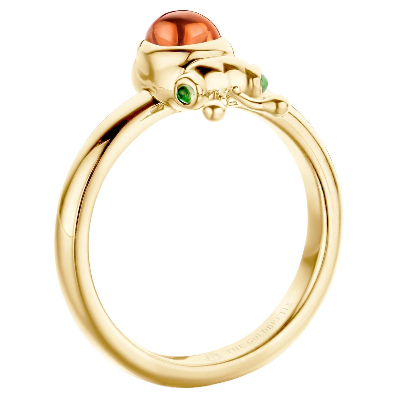 18-karat yellow gold Lilou ring set with one natural pear-shaped cabochon Mandarin Garnet and two natural Tsavorites in round cabochon cut.
Celine Roelens, a goldsmith and gemologist, specializes in unique, fine jewelry, handmade in Belgium and