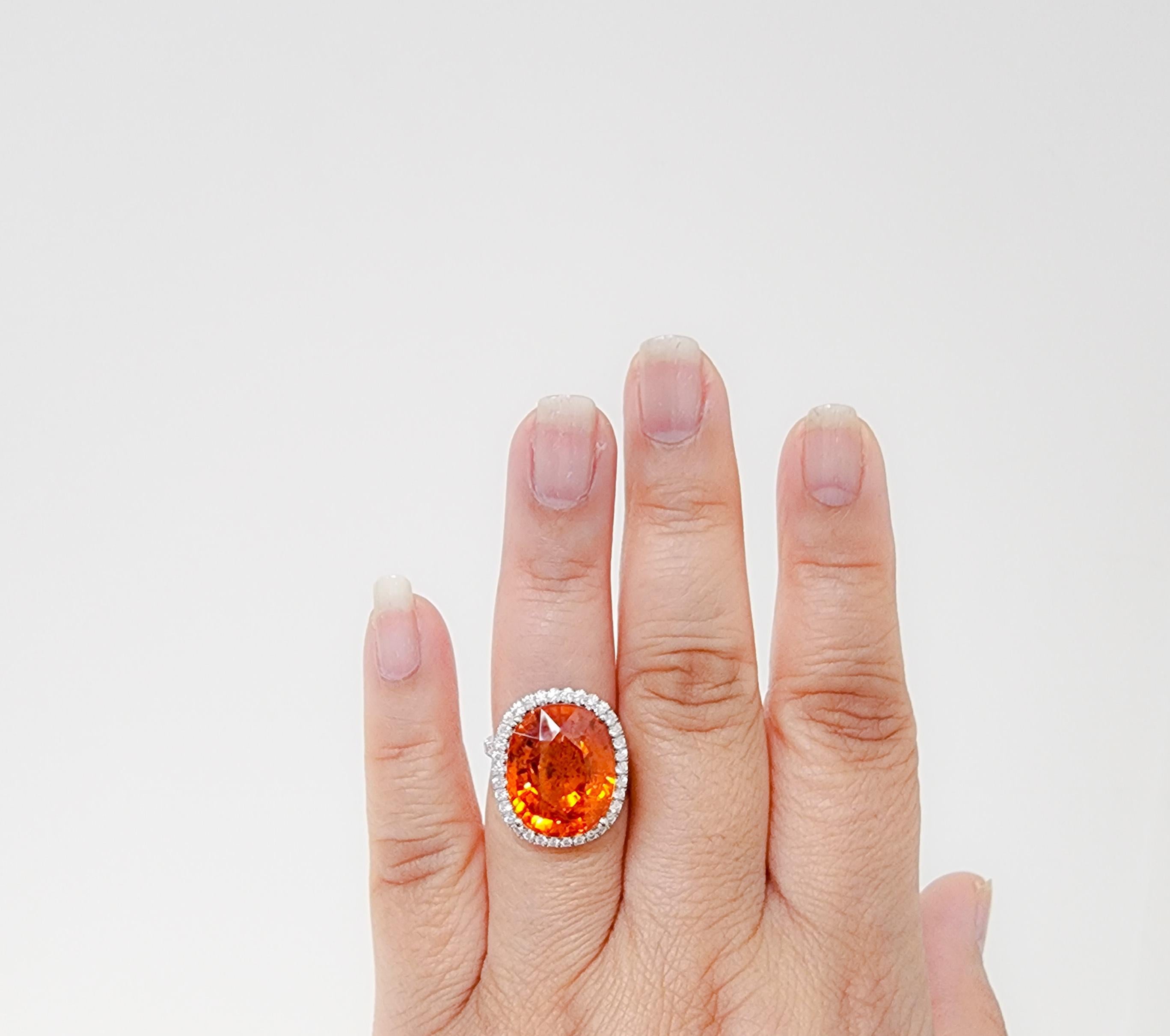 Gorgeous 21.50 ct. Mandarin garnet oval with 0.89 ct. good quality, white, and bright diamond rounds.  Handmade in platinum.  Ring size 6.75.