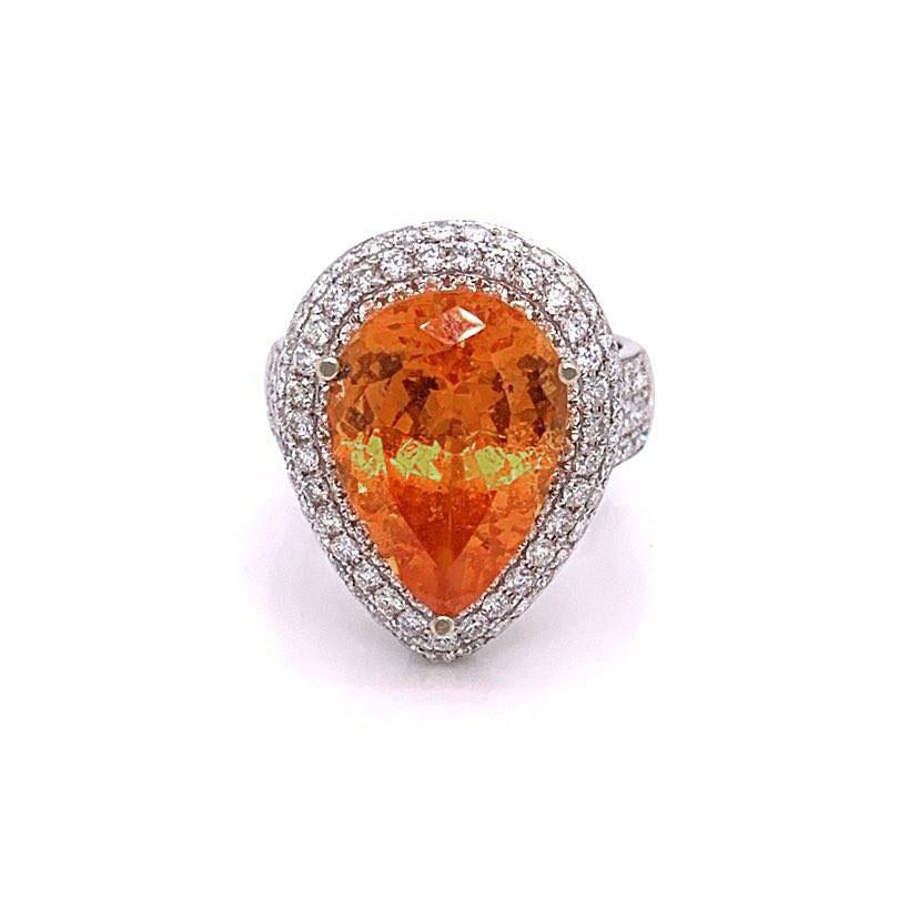 A special stone: weighting in at 10.35 carats and cut as a pear shape this mandarin garnet can be a collectors stone. It has a bright and vibrant orange color and free of any large inclusions that take away from the stone. It is accented and
