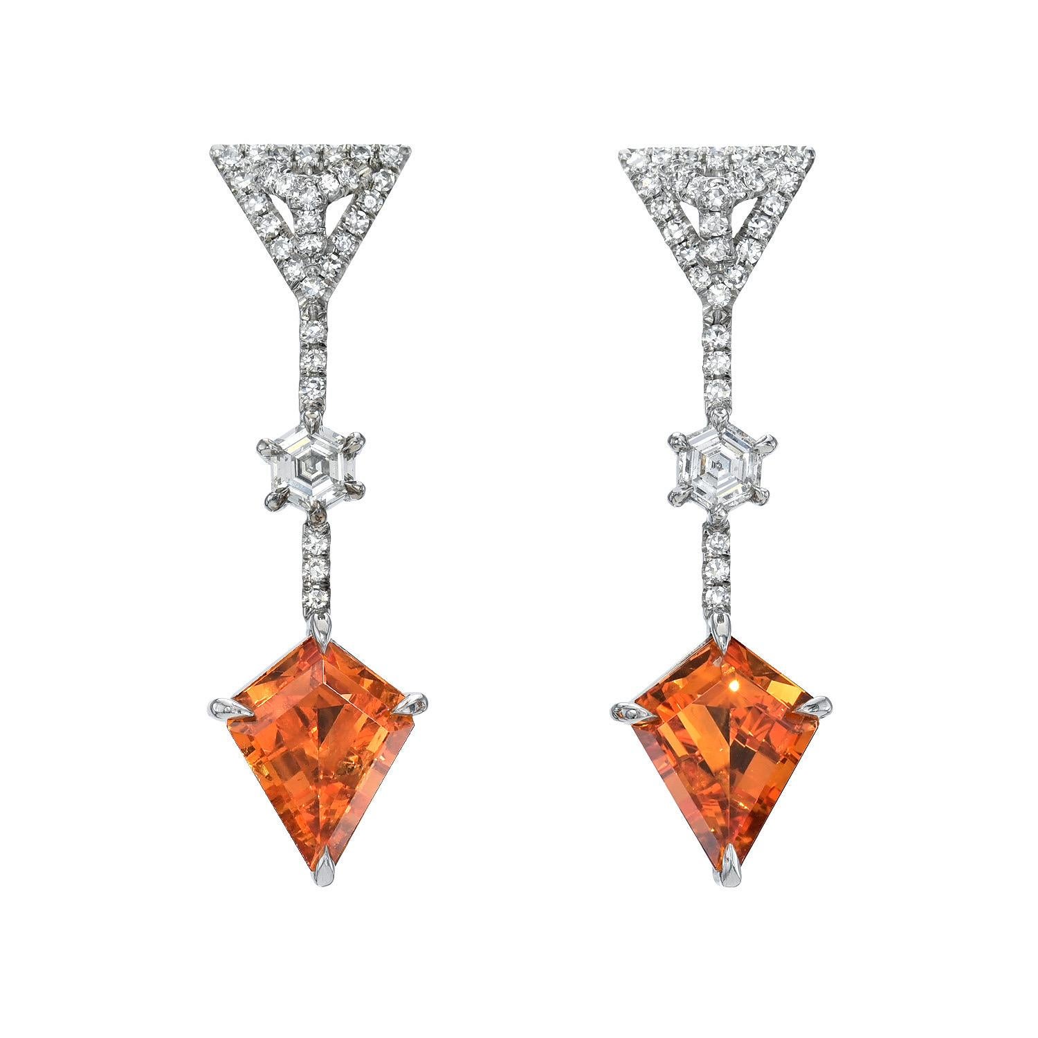 Spectacular pair of 3.38 carat total kite shaped Mandarin Garnet earrings, decorated with a pair of 0.31 carat D-F/VS1 Hexagon  diamonds and a total of 0.31 carat single cut collection diamonds. 
Crafted by extremely skilled hands in