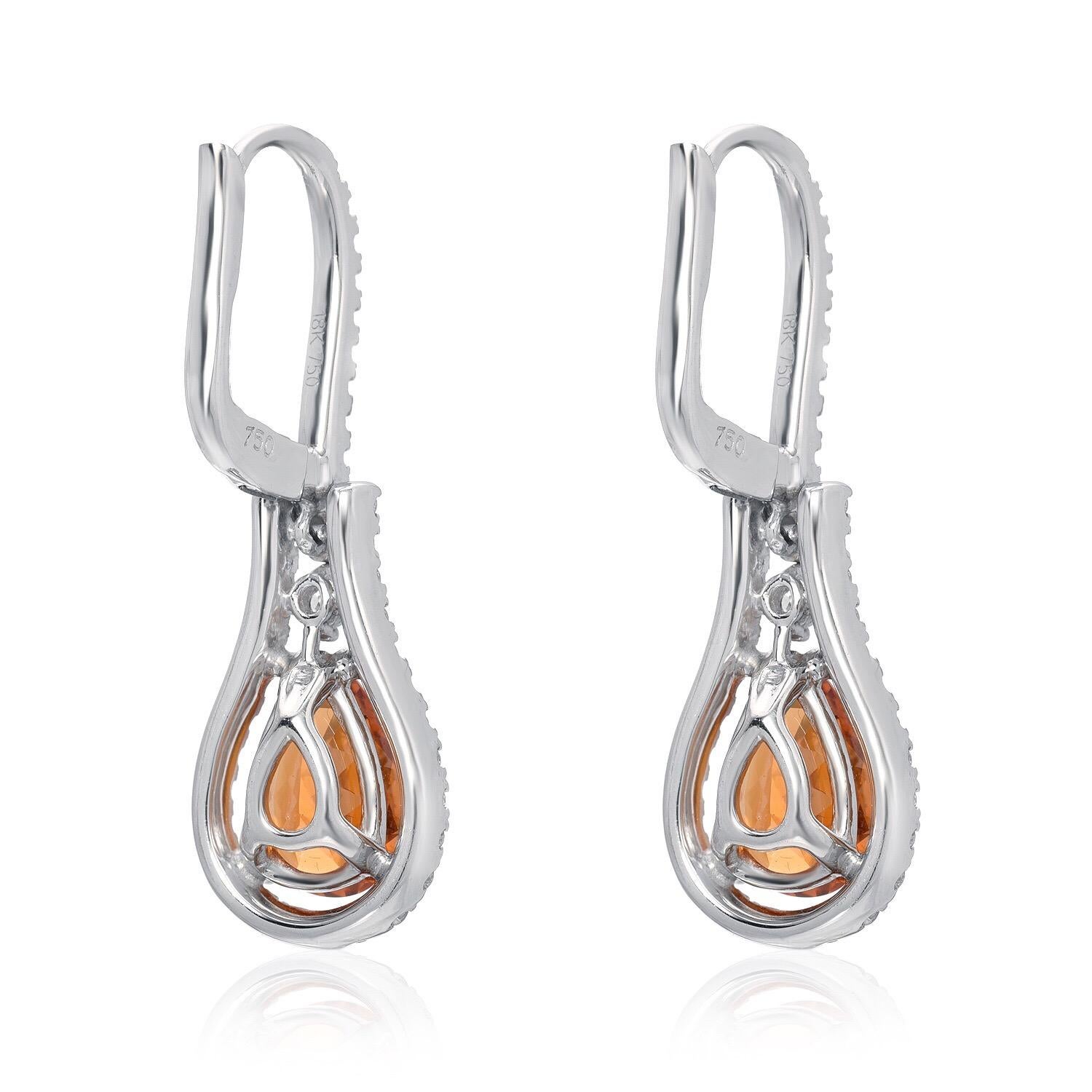 Mandarin Garnet pair of pear shapes, weighing a total of 3.43 carats, adorned by round brilliant diamonds weighing a total of 0.73 carats, are composing this vibrant pair of drop lever back 18K white gold diamond earrings for women.

1.25 inches in